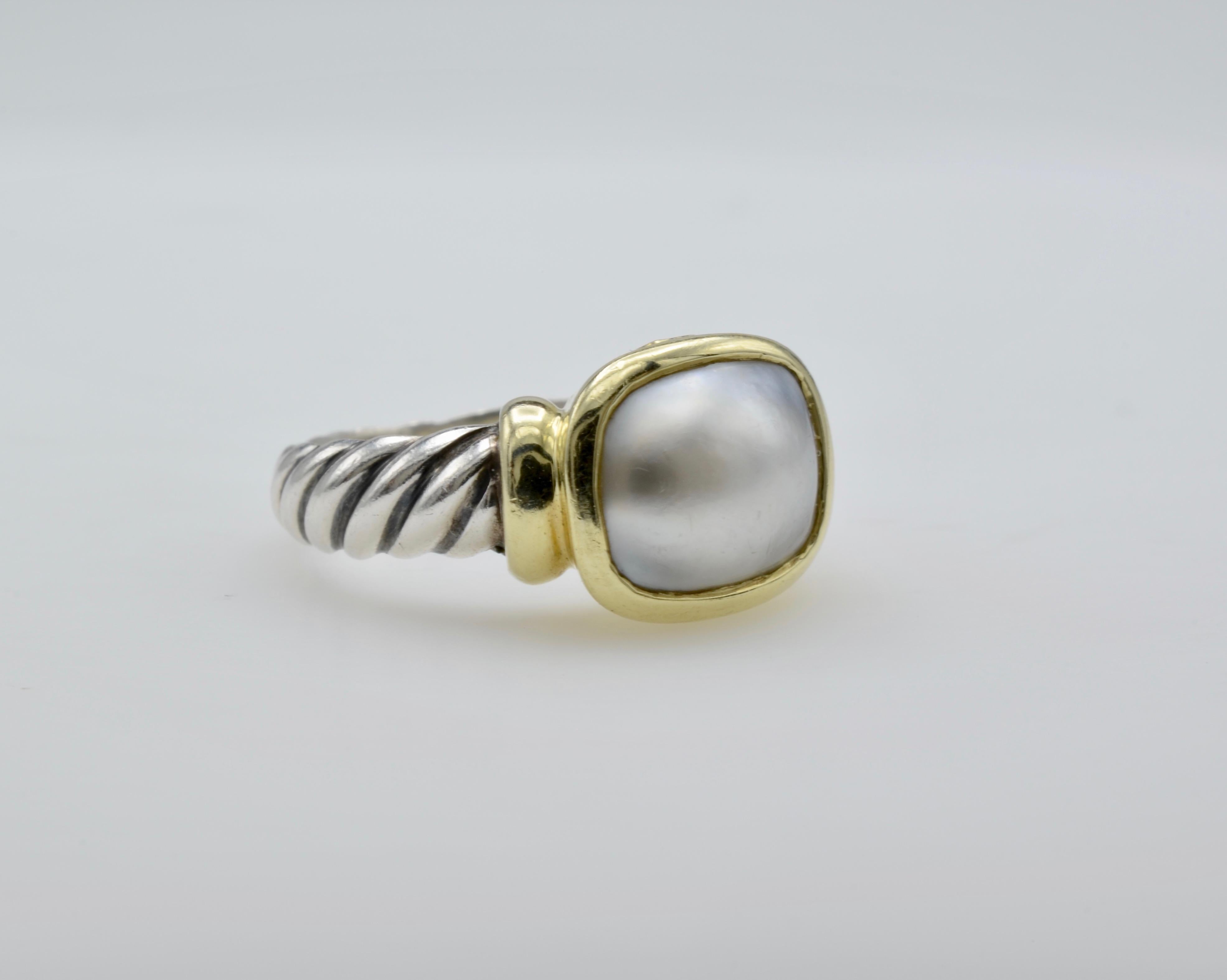 This stunning and classic ring is the perfect addition to your jewelry wardrobe.The white pearl is beautifully set in 18k gold bezel with D. Yurman signature twisted band in size 8. This ring can be sized to fit your finger.