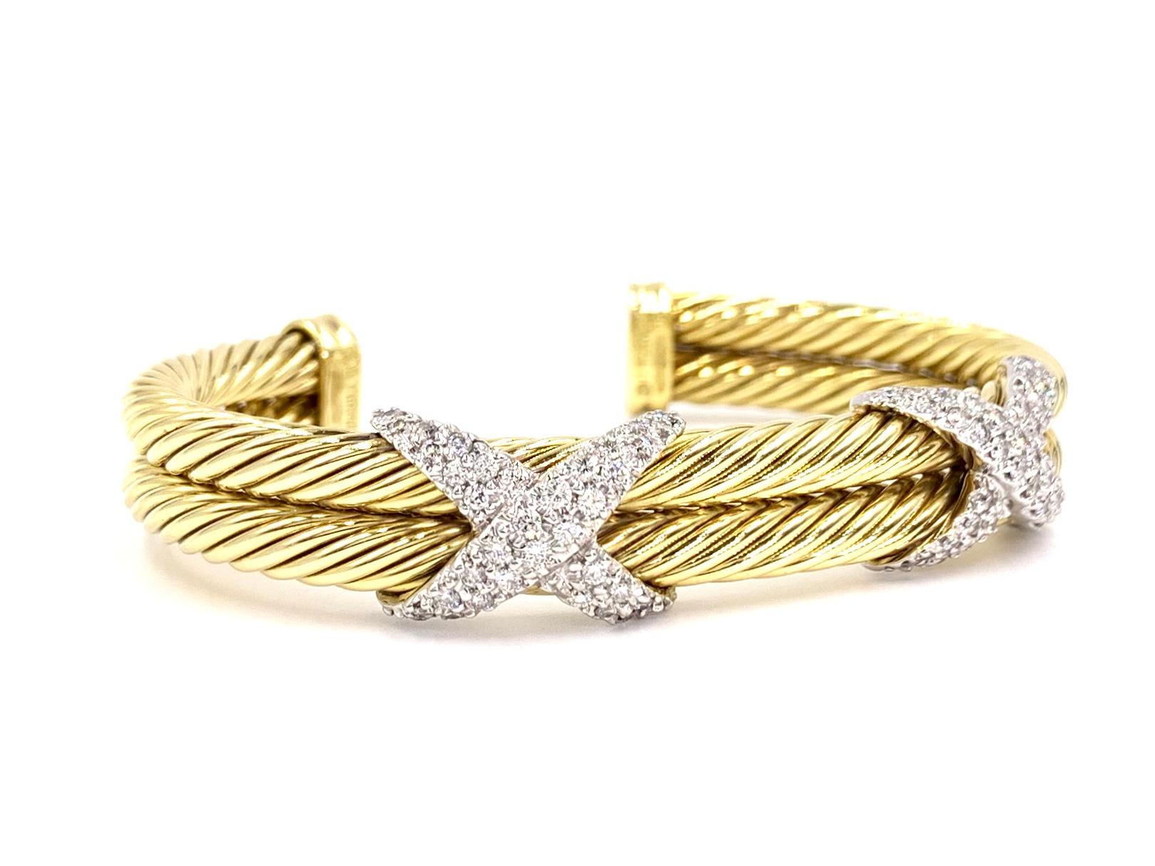 Signed David Yurman 18 karat yellow gold 10mm double cable oval cuff bracelet featuring two pavé diamond X's with approximately 1.50 carats total weight at approximately F-G color, VS2 clarity. Diamonds are set with white gold white gold prongs for