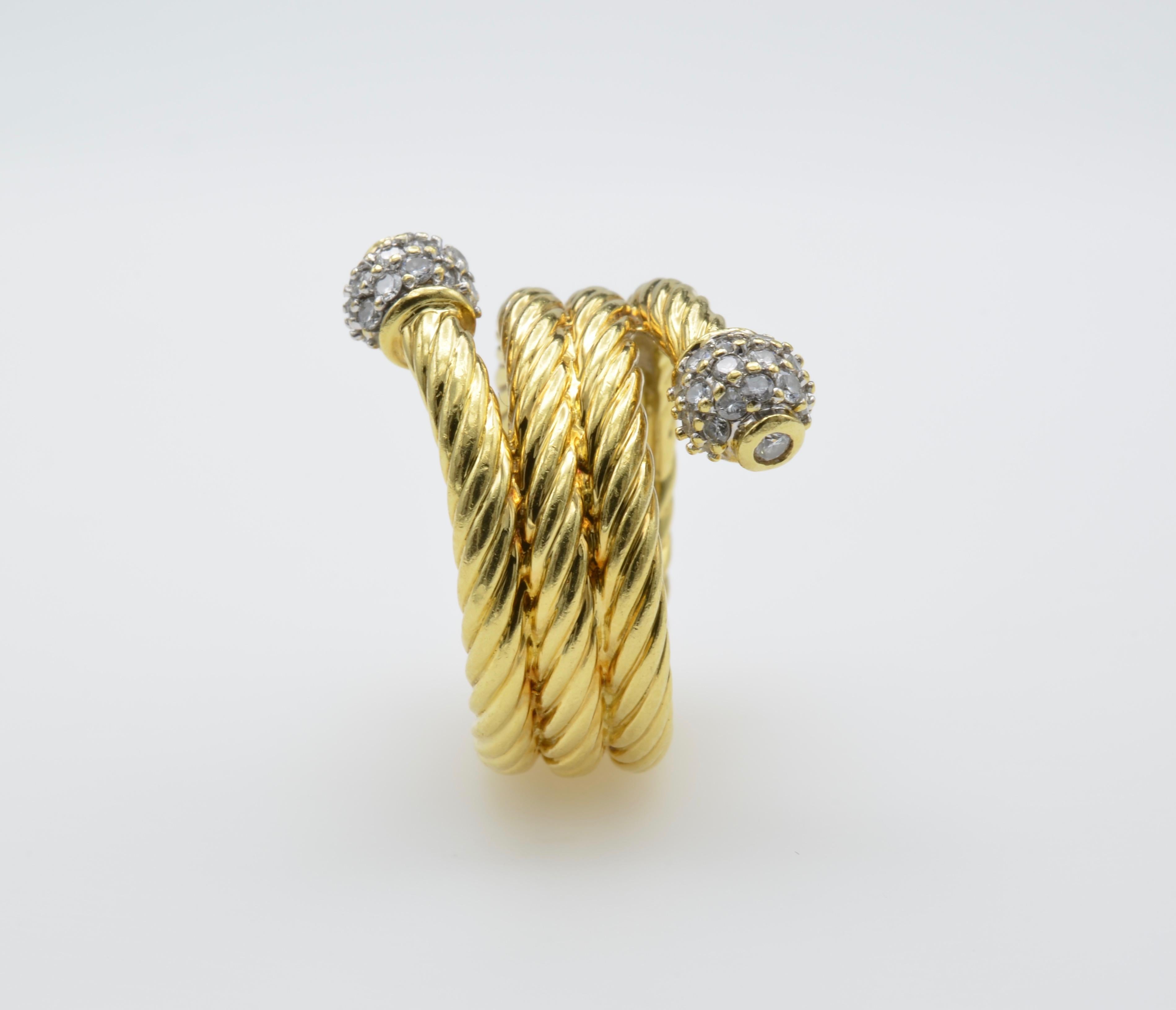 Golden yellow rope wraps around your finger with pave diamond balls on the end. An artistic piece made by David Yurman. There is movement and allure with this classic piece. The texture is divine and the sparkle illustrious. 18 Karat Yellow Gold and