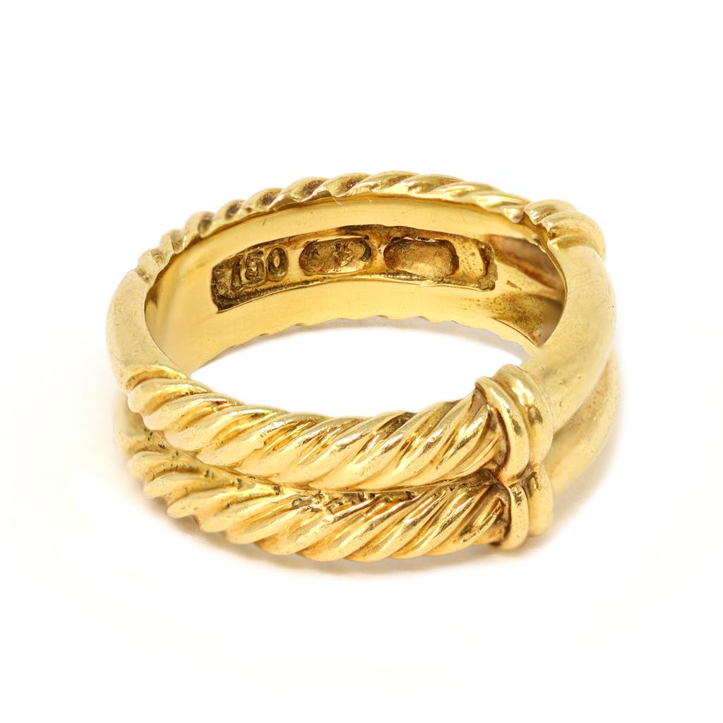 A signed David Yurman cable band ring in 18K yellow gold size 6 ½, circa 2000. Featuring the iconic cable motif, this 18K yellow gold David Yurman band ring showcases two rows of cable twists flanking a wide center focal point. Weighing 8.1 grams