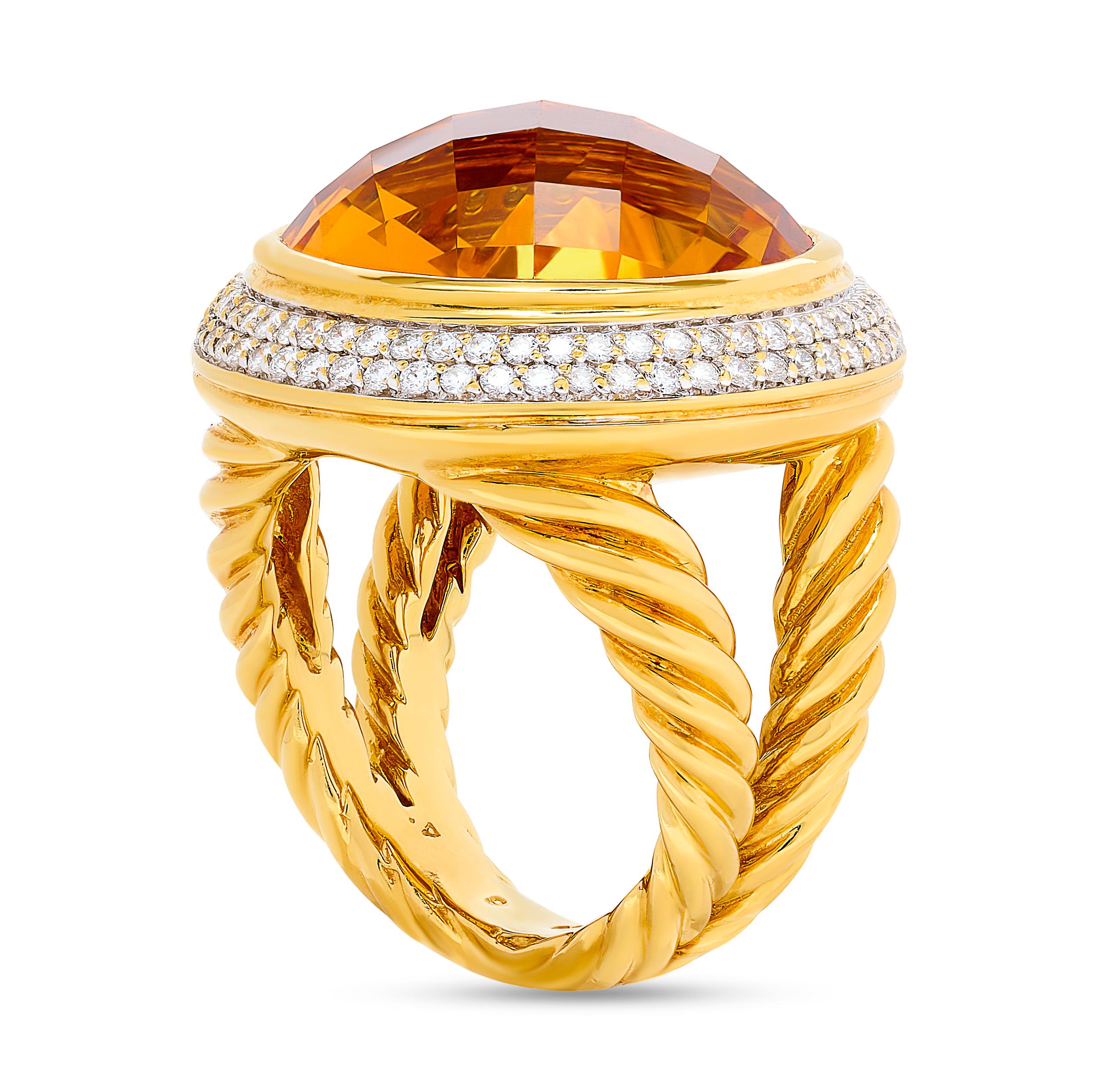 The David Yurman large citrine and diamond halo ring elegantly combines the warm glow of citrine with the brilliance of diamonds, creating a stunning piece of jewelry.

This 18k yellow gold ring features a large round citrine center gemstone. There