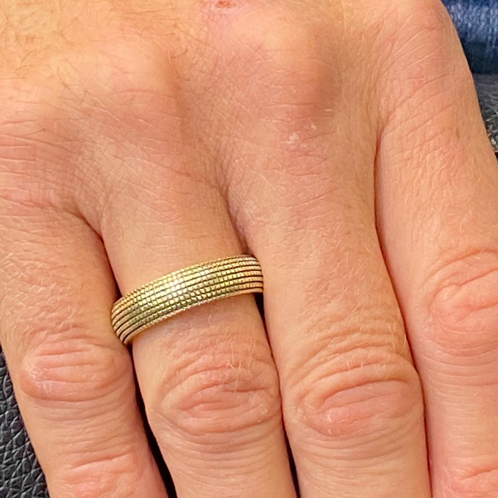 David Yurman 6mm Sky band ring fashioned in 18 karat yellow gold. The band features a unique blackened grid style pattern and is size 9.75. Signed David Yurman 750. 

