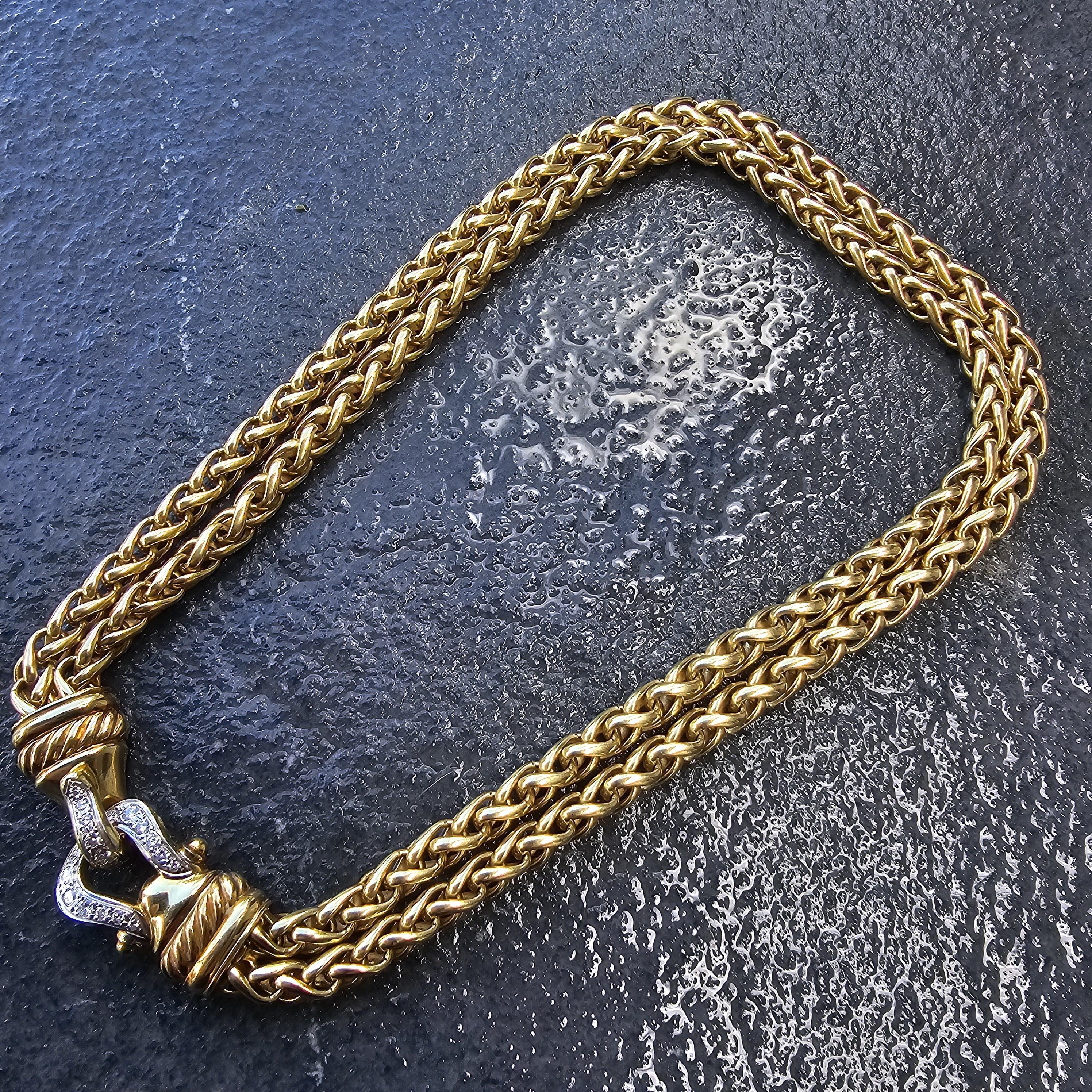 Elevate your collection with this exquisite David Yurman double wheat chain diamond clasp buckle necklace. Crafted from 18k gold, this piece showcases a luxurious woven design. The clasp is adorned with white diamonds, adding a touch of brilliance