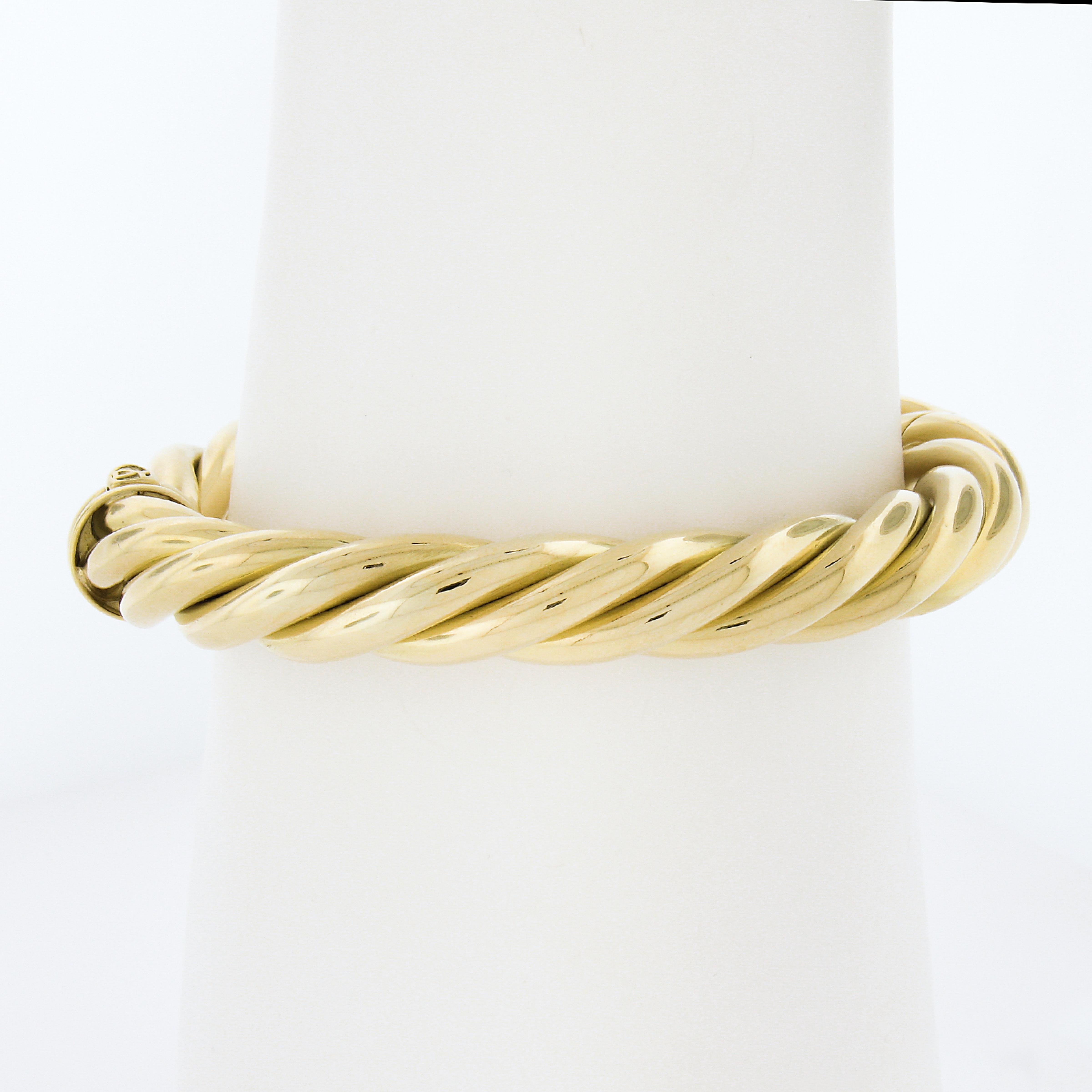 Material: Solid 18K Yellow Gold
Weight: 38.43 Grams
Type: Twisted Hinged Open Bangle Bracelet
Length: Will Comfortably fit up to a 6.75 inch wrist (Fitted on a wrist)
Clasp: Push Clasp
Width: 9.5mm (0.37