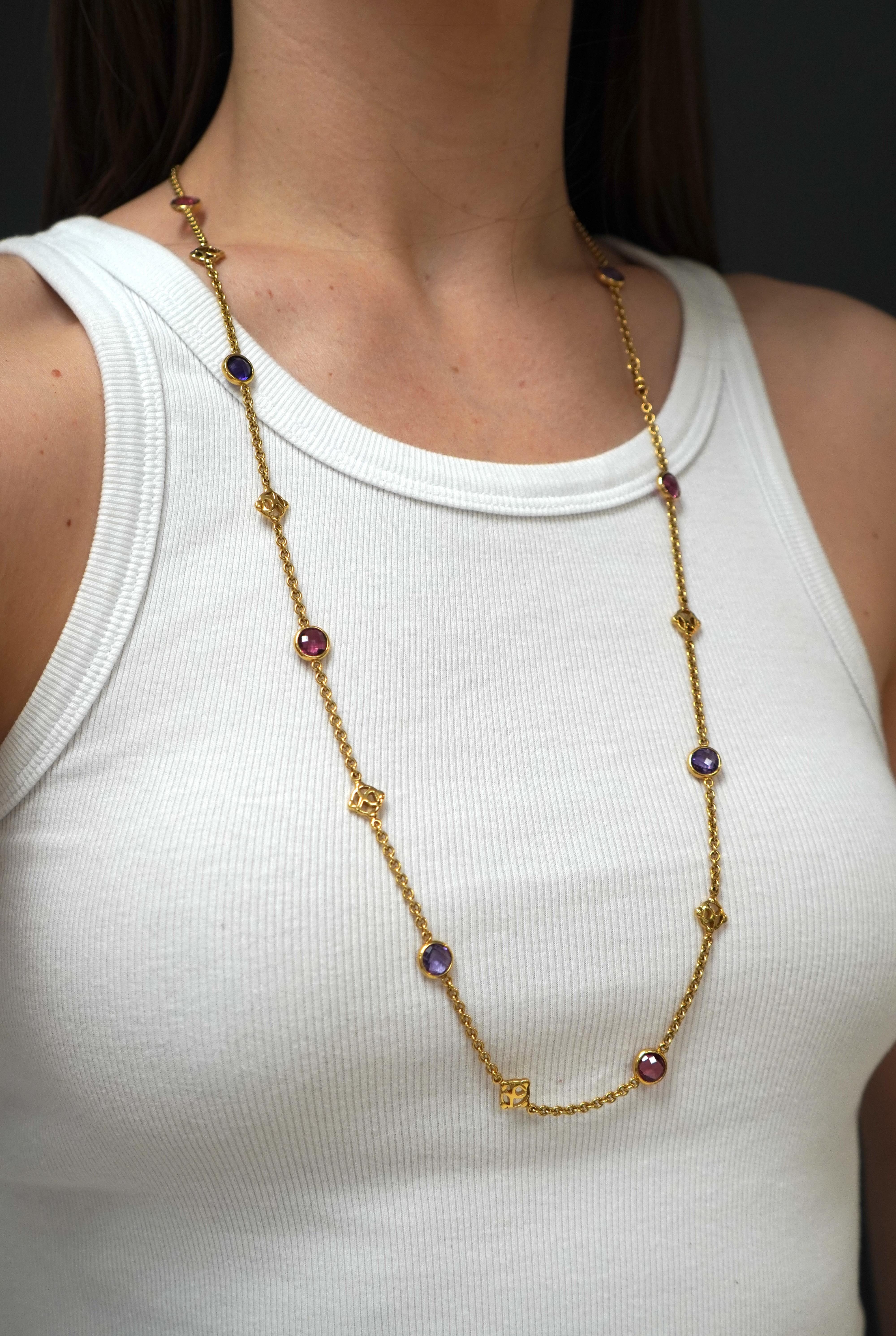 This 18k gold necklace by David Yurman is from the late 1990s Albion collection. Measuring 33 inches in length and 1/4 inch in width, it weighs 38.3 grams. The design features a repeating pattern of bezel-set amethyst and pink tourmaline stones,