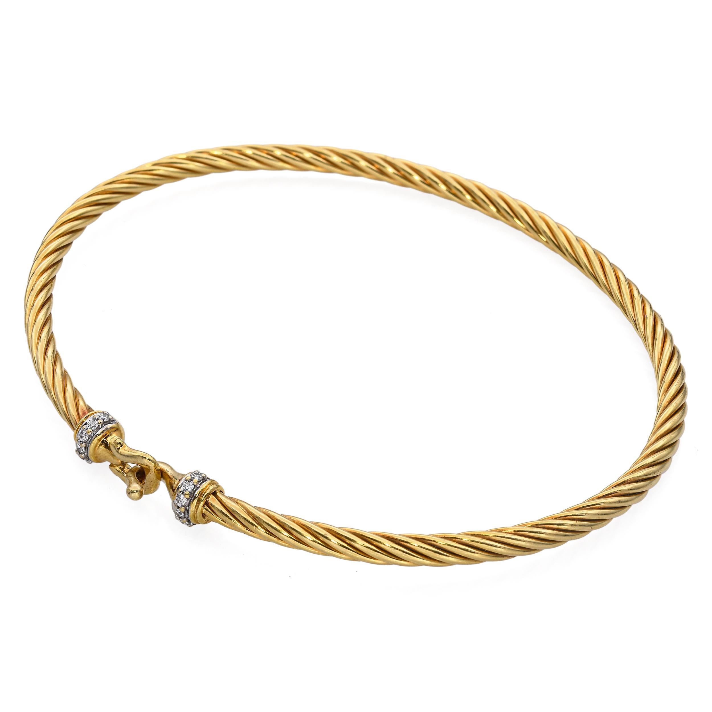 This David Yurman 18k yellow gold cuff bracelet showcases the designer’s iconic braided cable motif, elevated with the addition of brilliant diamond accents. The twisted gold design embodies both strength and fluidity, while the diamonds add refined