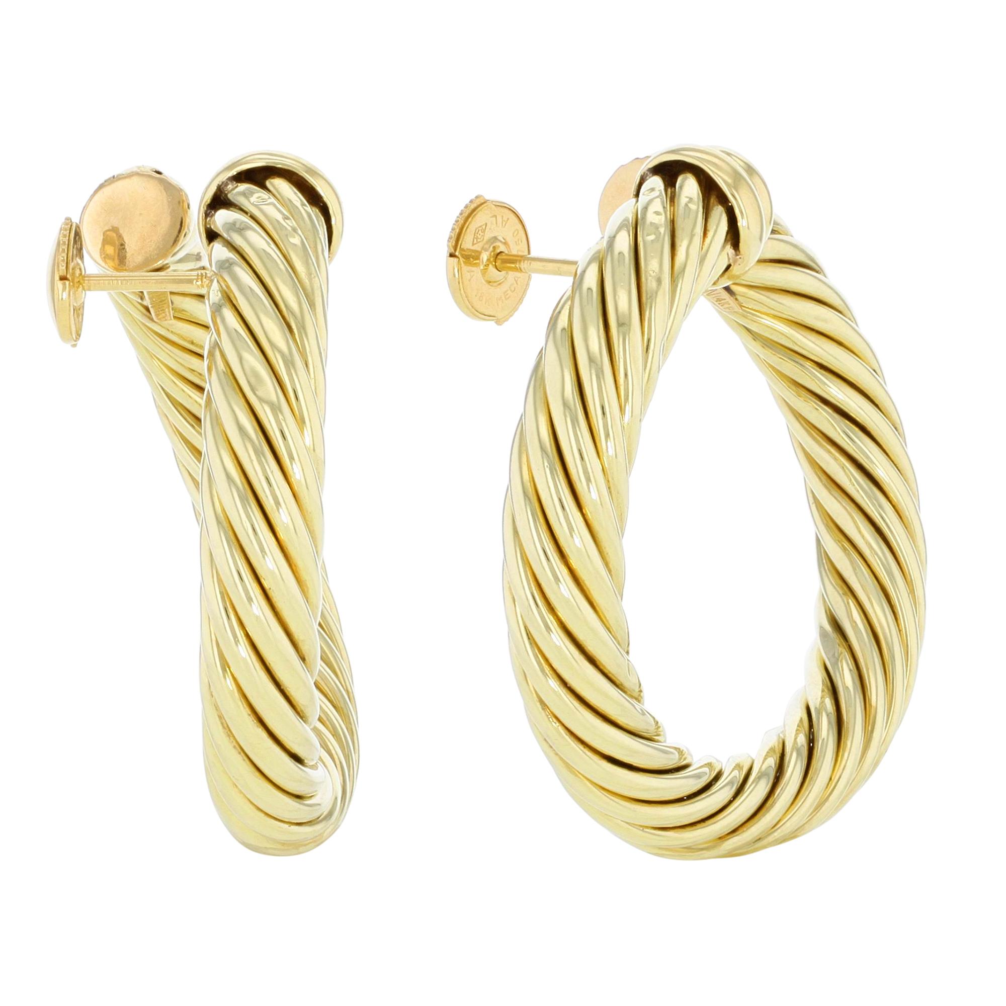 These David Yurman Classic Cable earrings are crafted in 18k yellow gold. Earring size: 40mm. Thickness: 7mm. Weight 22 g. Pre-owned like new, original packaging is not included, comes in our presentation box. 

