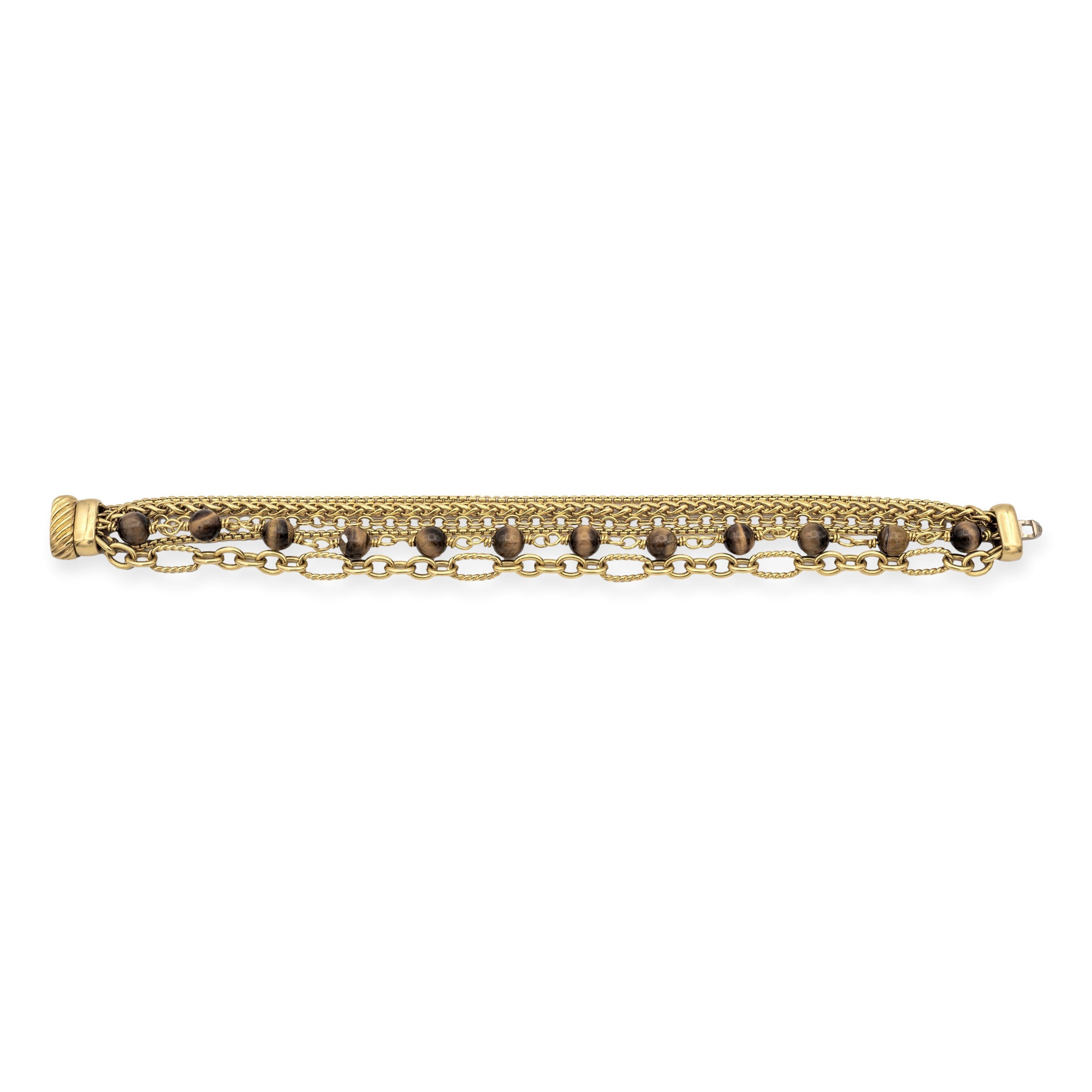 This David Yurman Multi-Chain Bracelet features six intricately crafted strands from Yurman’s signature link chain collection, including tiger-eye spiritual beads, measuring 6 mm each, box , wheat  ,  oval, and cable link chains.  The bracelet is