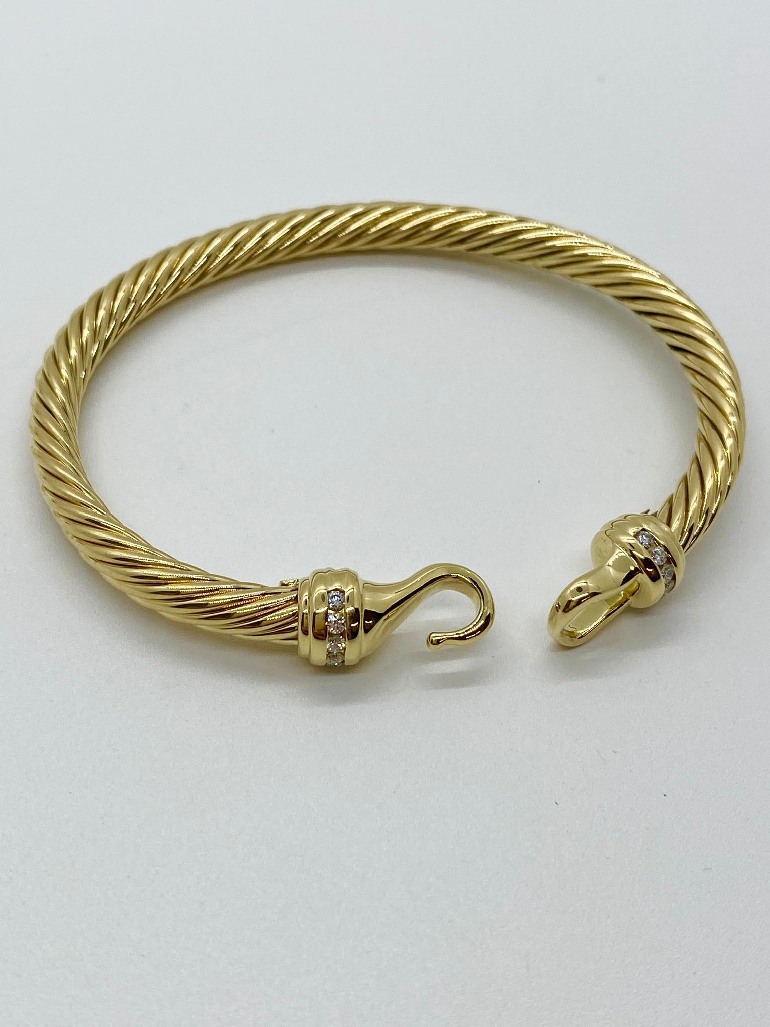 Vintage David Yurman 18k yellow gold and diamond classic cable bangle bracelet.  Diamonds are round brilliant cut and are approximately 0.12 carat total  weight G-H color and SI1-SI2 clarity.   Bracelet measures 6.5 inches for wrist size with hook