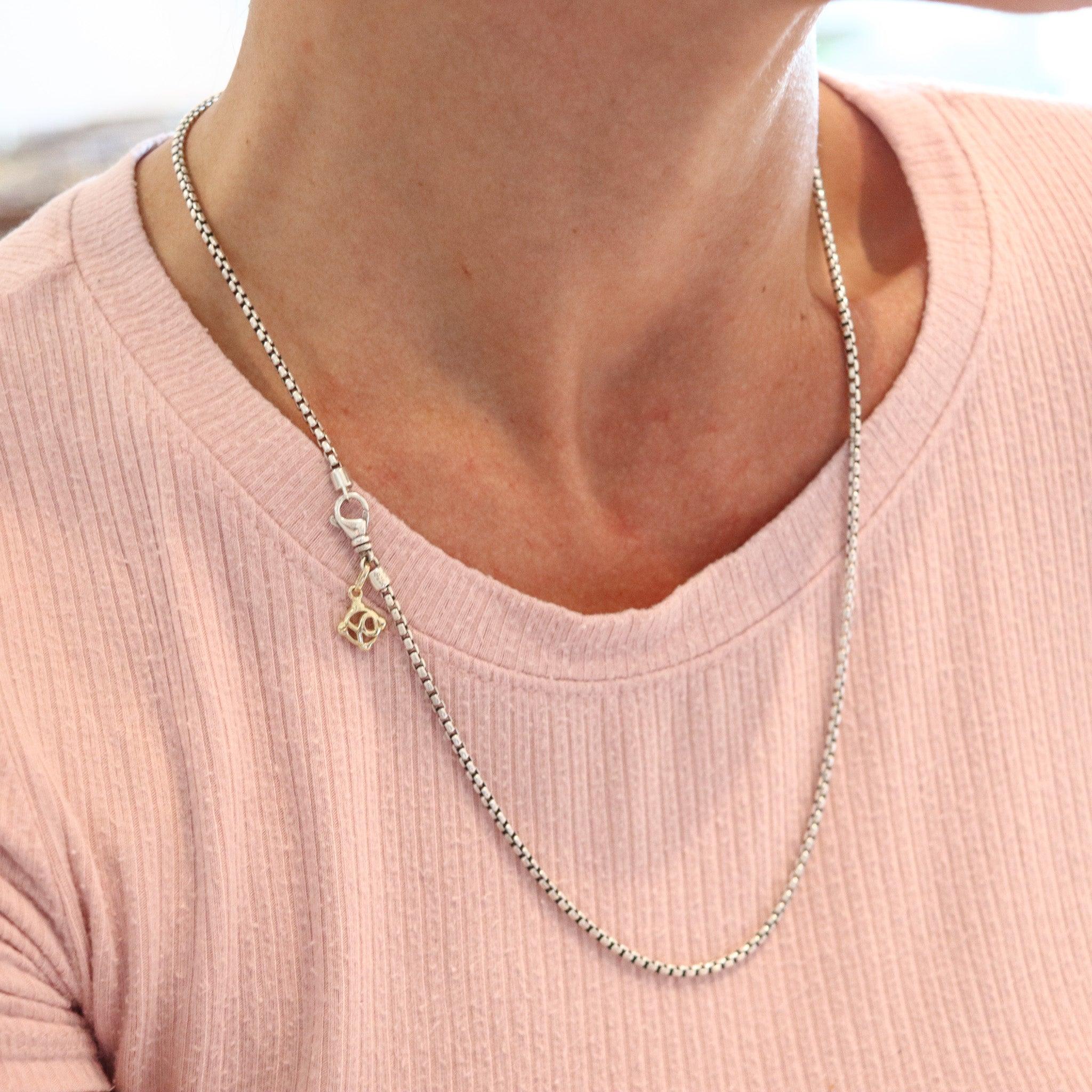 A chain designed by David Yurman.

This is a classic chain created by David Yurman. It is a vintage piece crafted in solid .925/.999 sterling silver with an accent in yellow gold of 18 karats. Has a length of twenty-tree inches and is fitted with a