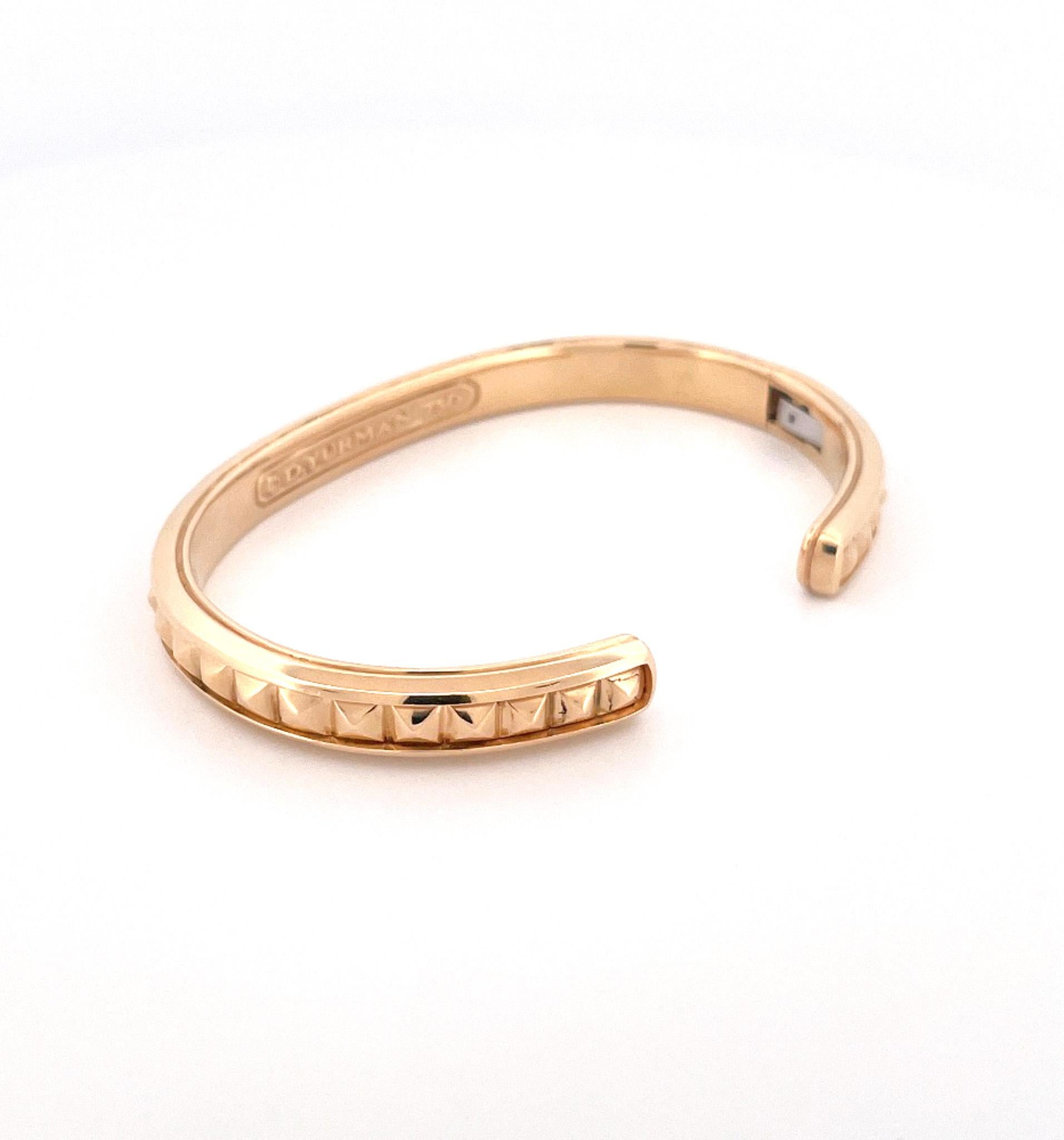 From designer David Yurman, circa 1990s, 18 karat yellow gold gentlemen's cuff bracelet. This bracelet is crafted with a ridged design along the center row. This bracelet is a men's small measuring 9 inches with a hinge side closure. This bracelet