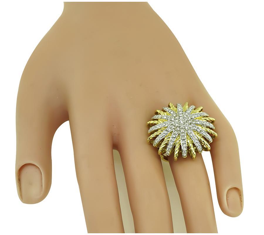 This is an elegant 18k yellow gold ring by David Yurman. The ring is set with sparkling round cut diamonds that weigh approximately 2.00ct The color of these diamonds is I with VS clarity. The top of the ring measures 28.5mm in diameter. The ring is