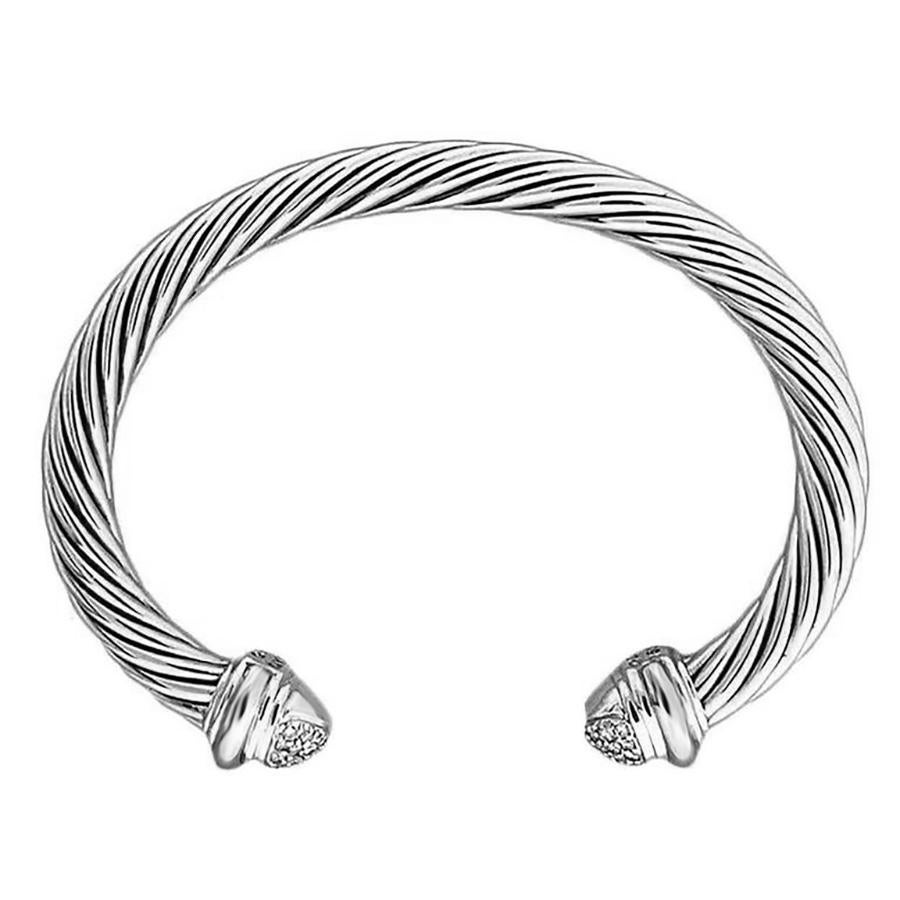 This exquisite David Yurman bangle bracelet features a harmonious blend of sterling silver and white gold. The silver 7mm cable bangle features 18k white gold end caps that are each adorned with 20 full cut diamonds in a dome form. This piece