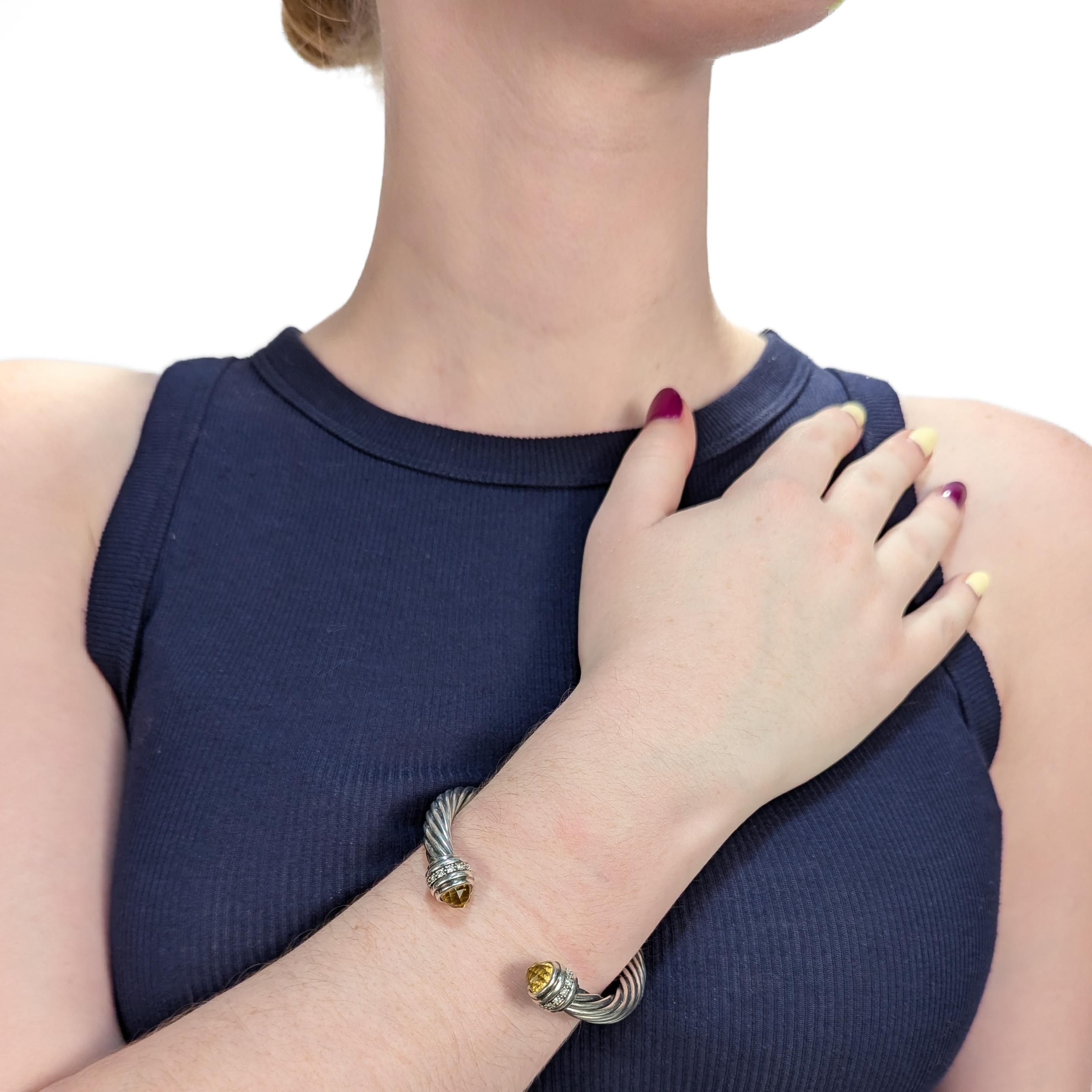 A fine signed silver, citrine, and diamond cuff bracelet.

By David Yurman.

In sterling silver.

In the 'Classic Cable' pattern.

Each terminal with a band of pave-set diamonds and a faceted bezel-set citrine cabochon.

Marked to the interior of