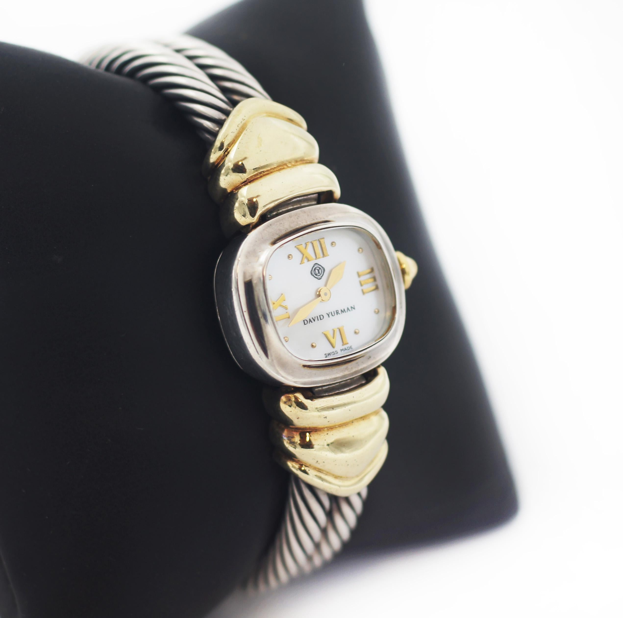 David Yurman,
925 sterling silver with 14k yellow gold accent
double cable band in sterling silver
push in clasp
lugs and crown are in yellow gold
Mother of Pearl Dial
Gold Roman numeral hour markers and hands
Gold crown
Sapphire crystal
Quartz