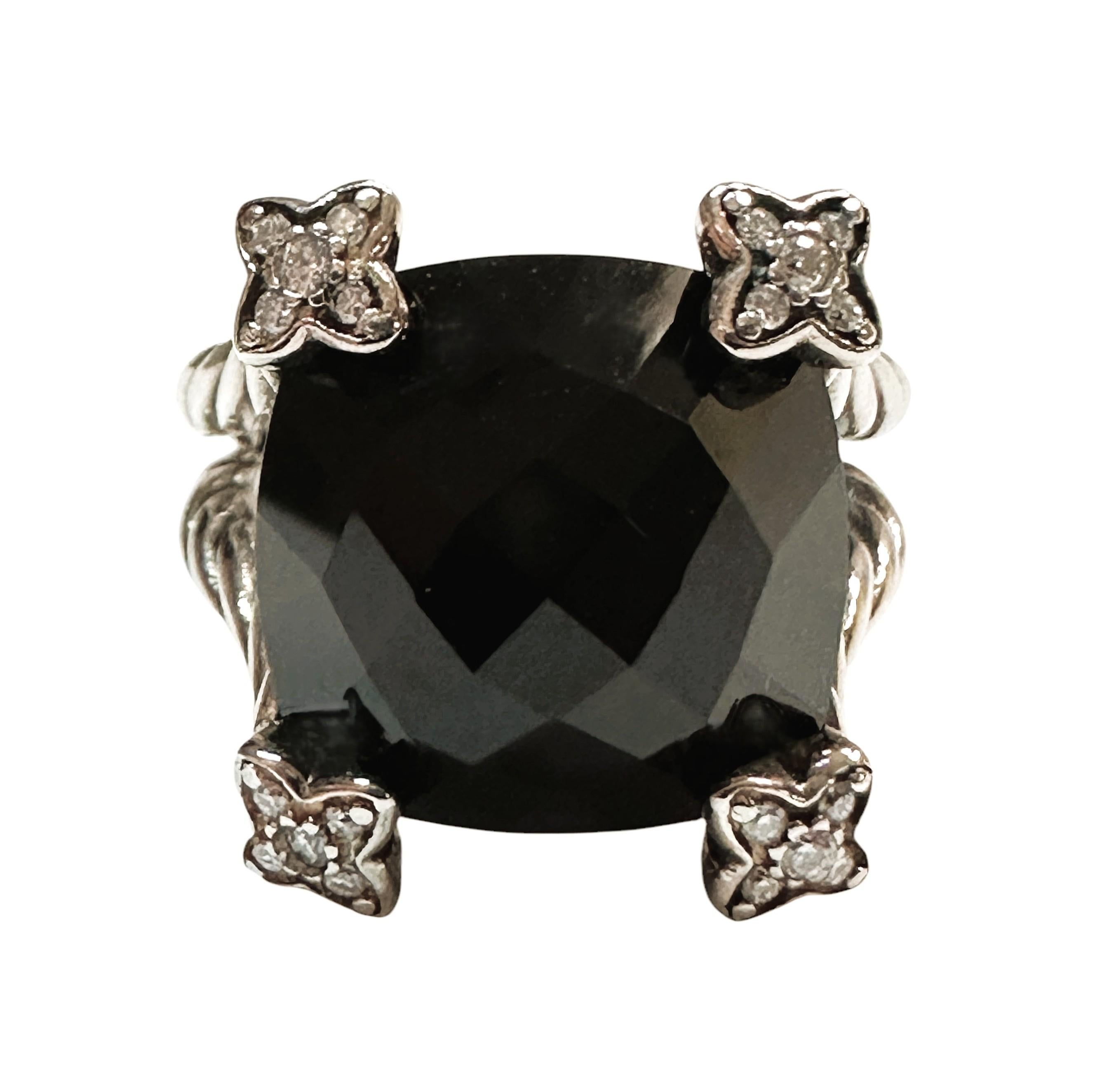 This is a beautiful David Yurman ring with a uniquely faceted  Black Onyx stone that measures  14 x 114 mm.  It is has natural Brilliant cut Diamonds on the 4 corners of the stone.  It comes with a brown David Yurman pouch and is hallmarked 