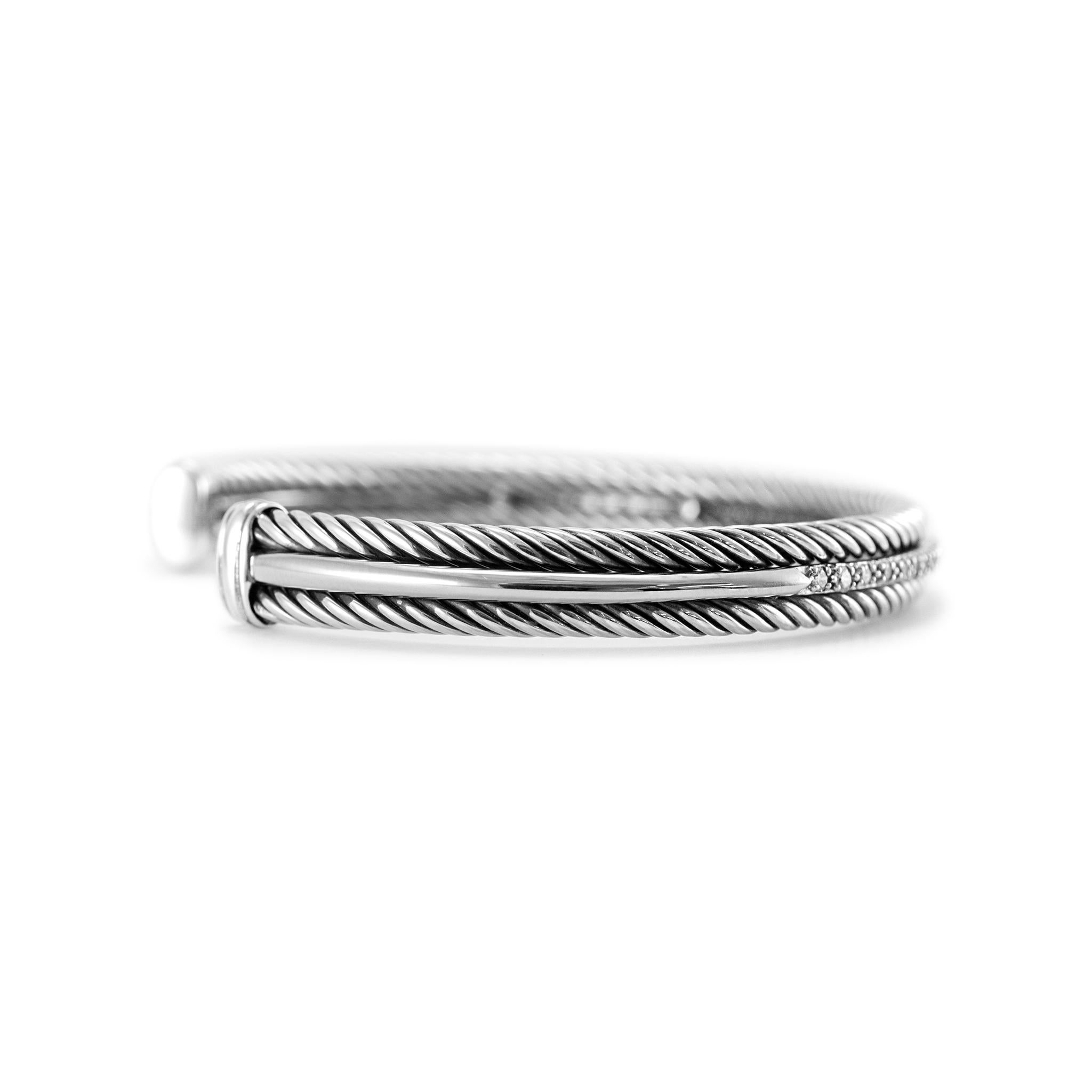 Brand: David Yurman

Gender: Ladies

Metal Type: 925 Sterling Silver & 14K White Gold

Length: 6.50 inches 

Width: 7.00 mm

Weight: 21.43 Grams

Ladies designer made textured & polished silver and 14K white gold, diamond cuff bracelet. The metals