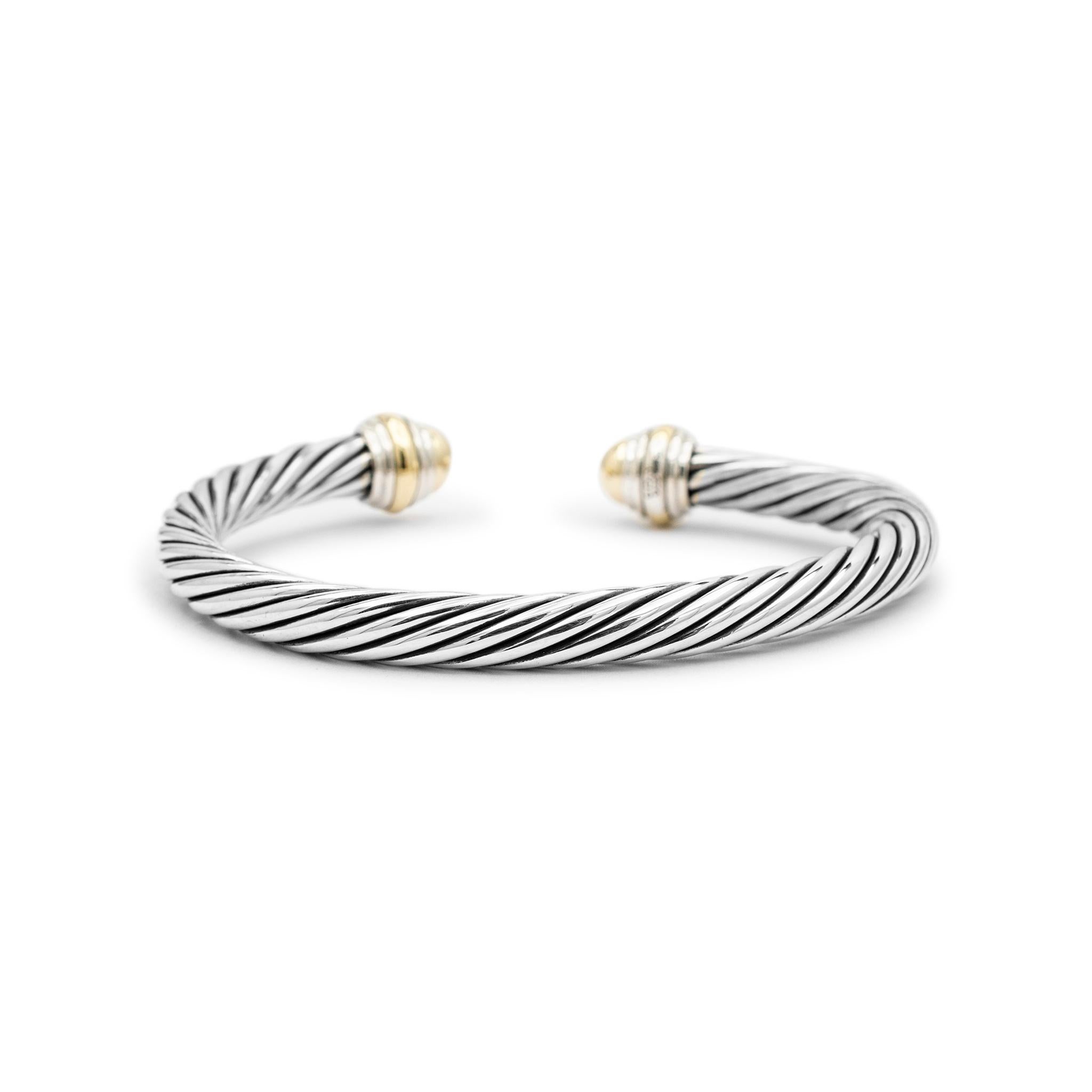 Brand: David Yurman

Metal Type: 925 Sterling Silver 14K Yellow Gold

Length: 7.50 Inches

Width: 7.00 mm

Weight: 48.00 grams

14K yellow gold and silver cuff bracelet. Engraved with 
