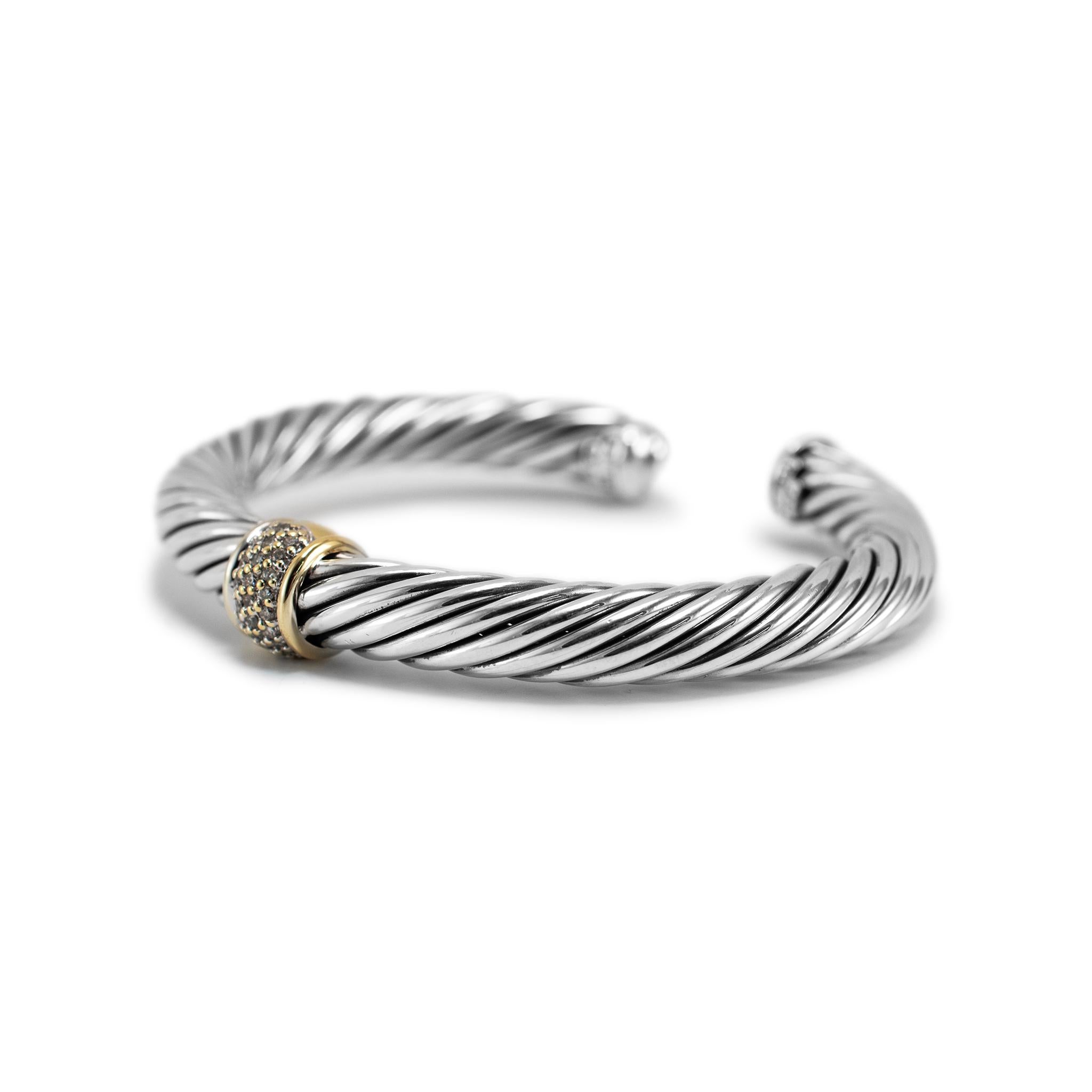 Brand: David Yurman

Gender: Ladies

Metal Type: 18K Yellow Gold & 925 Sterling Silver

Length: 6.00 inches

Width: 7.00 mm

Weight: 42.10 grams

Ladies designer made textured & polished silver and 18K yellow gold diamond cuff bracelet. The metals