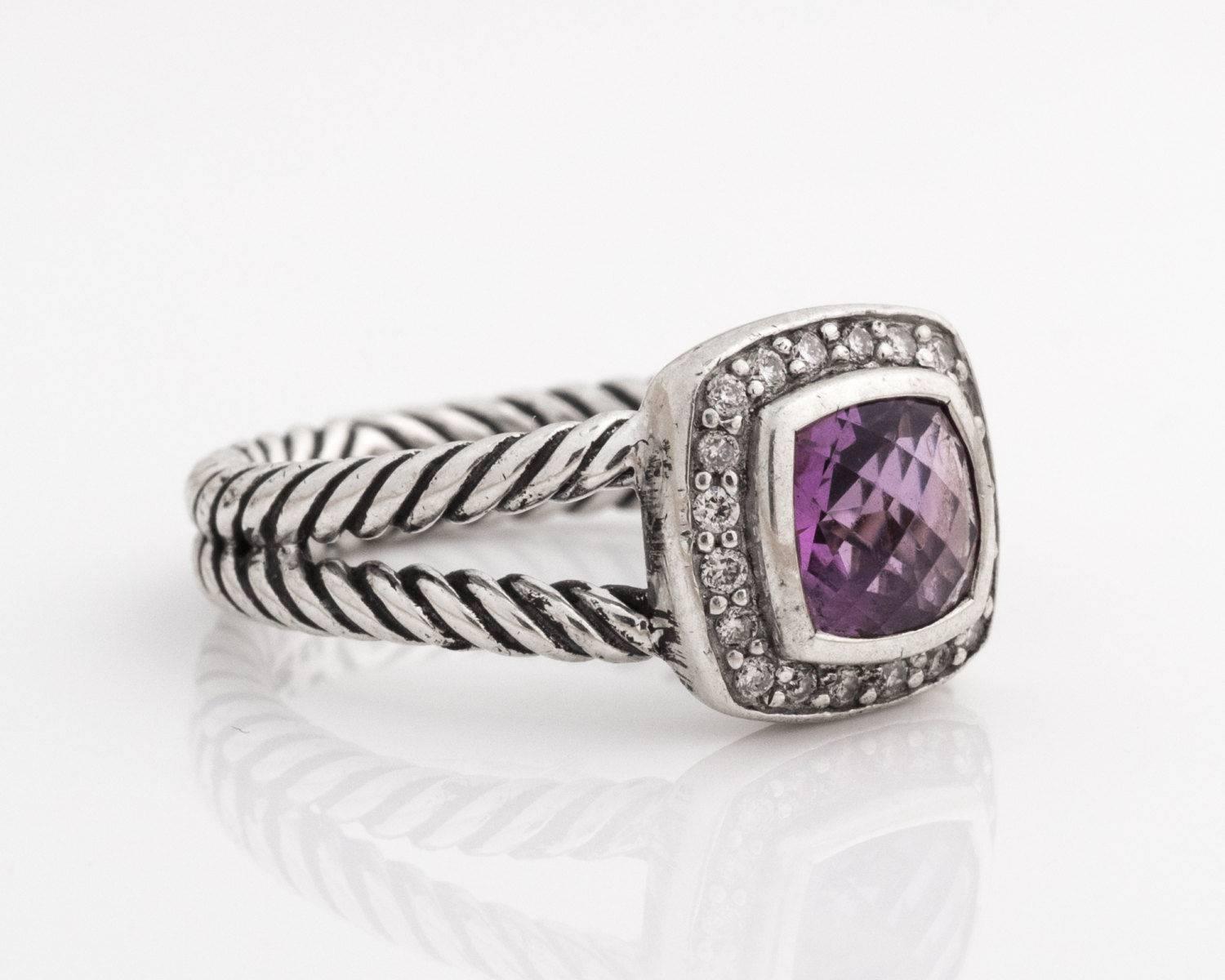 David Yurman Albion Ring - Sterling Silver, Amethyst, Diamonds

Features a faceted square cut Amethyst surrounded by a halo of diamonds. All of the gems are set in bezel frames. The Yurman cable ring has split shoulders. The cables meet halfway
