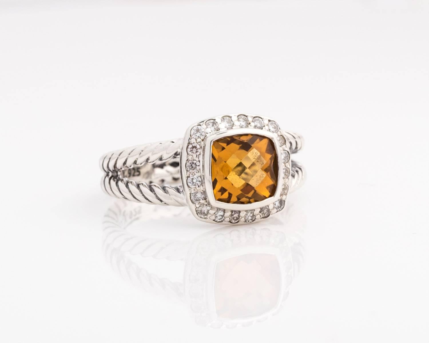 David Yurman Albion Ring - Sterling Silver, Citrine, Diamonds

Features a faceted square cut Citrine surrounded by a halo of diamonds. All of the gems are set in bezel frames. The Yurman cable ring has split shoulders. The cables meet halfway around