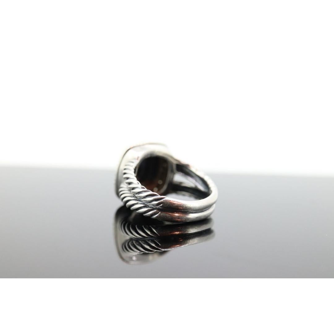 Vintage from the 1980s
Size: 8 US
Materials: Silver
Gemstone: Hematite

 Band color: Gold

Iconic David Yurman Jewelry. Beautiful Cable Ring with Center Hematite and Diamond Halo.

Conditions: Show some characteristic signs of age. Comes with