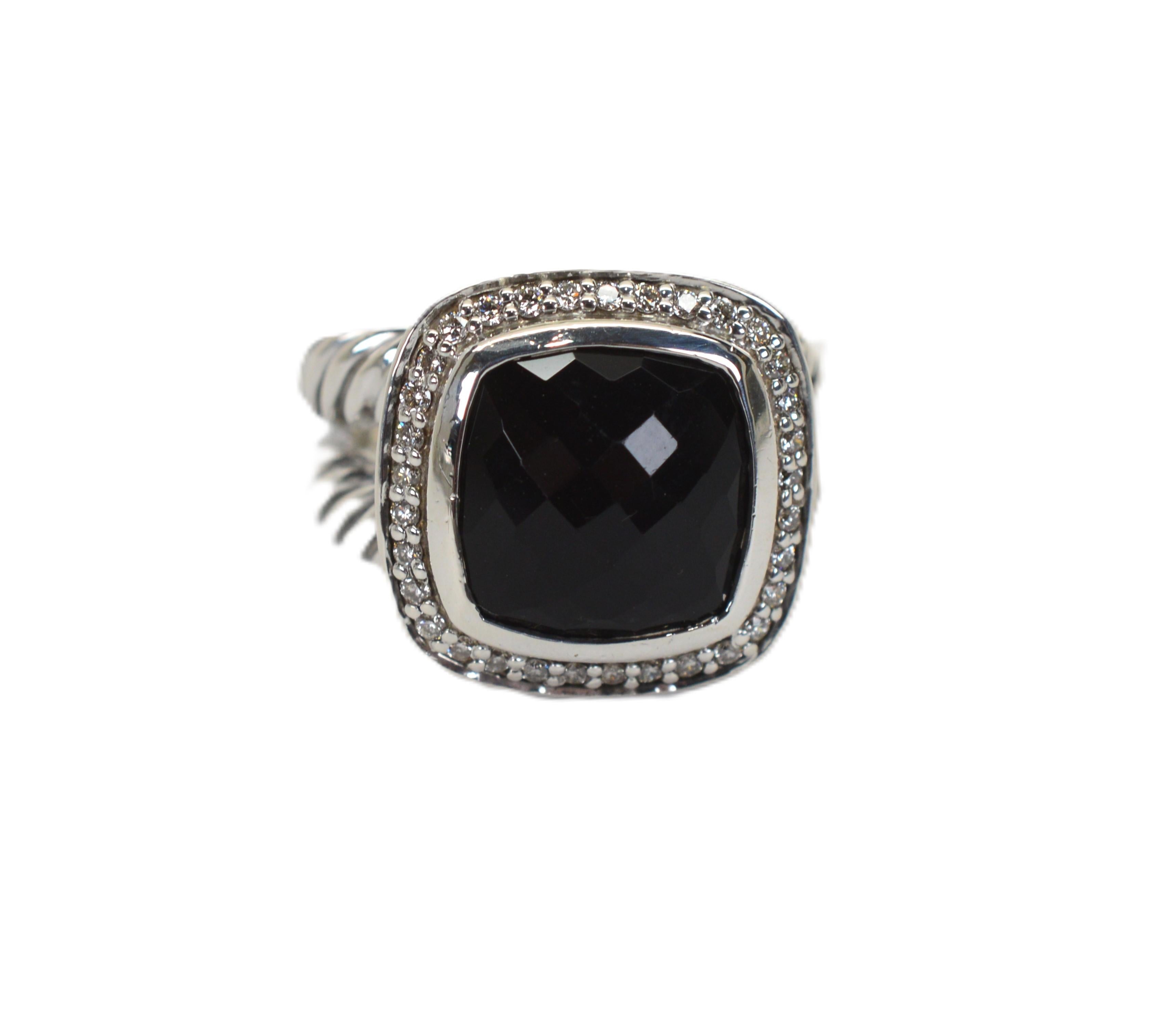A David Yurman classic style that is current today in the David Yurman Albion Ring Collection. In sterling silver, with a jet black 11mm faceted cushion cut black onyx surround by a halo of pave diamonds, .19 carat TW. With Yurman's double cable