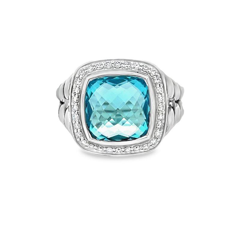 This exclusive design is renowned for its stunning centerpiece—a 7.00 CT blue topaz, meticulously cut into a beautiful cushion shape. This lustrous stone is elegantly encircled by 0.70CT of brilliant white round melee diamonds, accentuating the