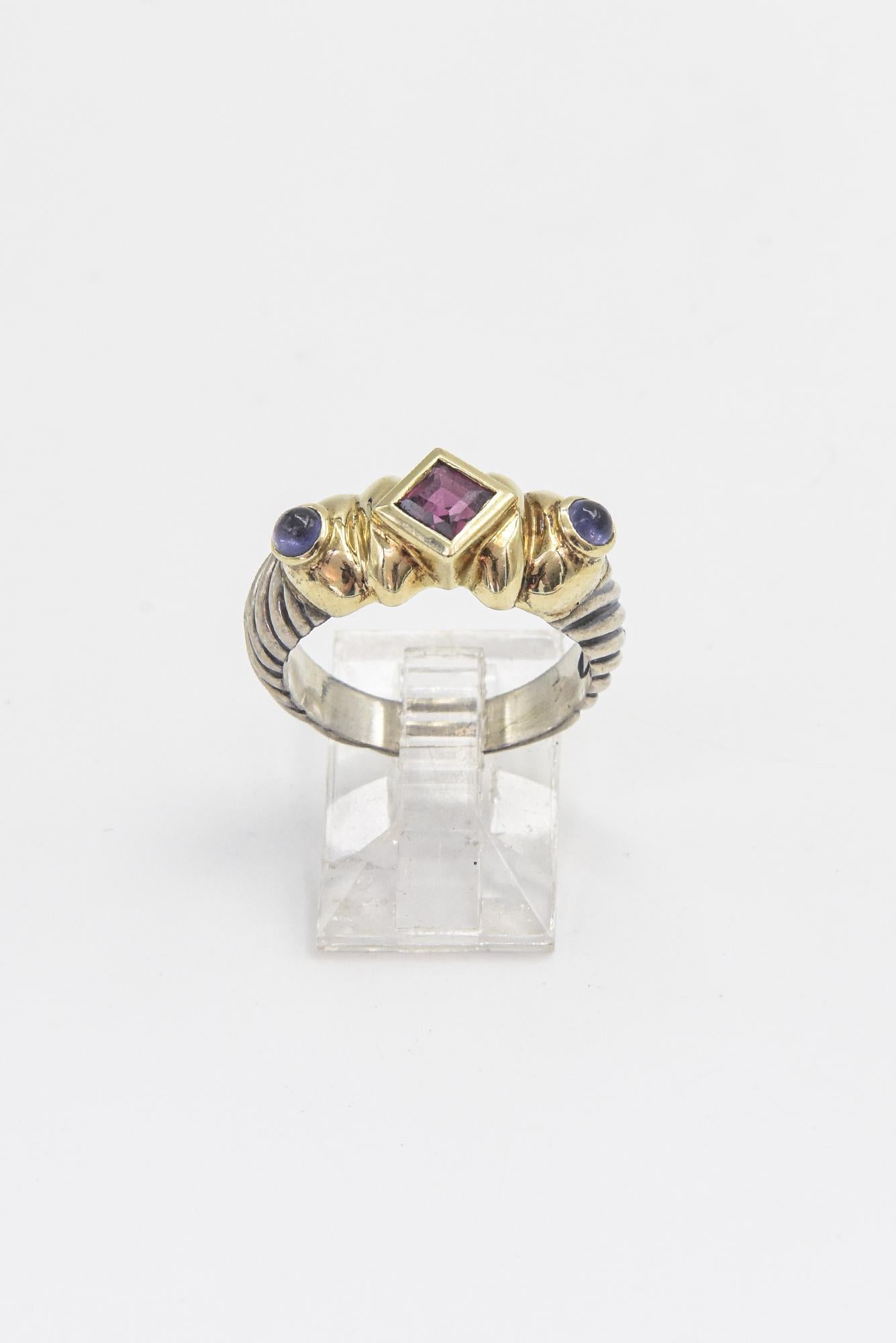 Vintage David Yurman Renaissance Ring part of the signature cable collection featuring a faceted square shape garnet set between 2 cabochon amethyst.  The ring is sterling silver with 14k yellow gold accents.  Measures .85