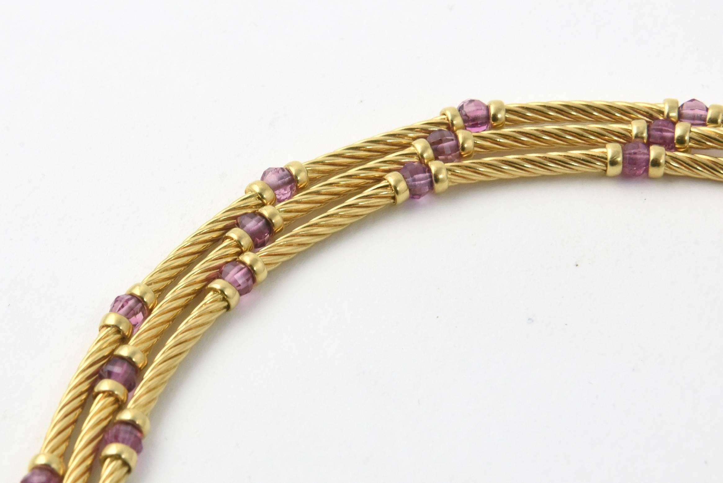 David Yurman 18K yellow gold choker necklace composed of three strands of twisted cable wire adorned with vibrant amethyst beads set between each section. Total weight: 72.6 grams. Marked: 750 DY. Age wear.