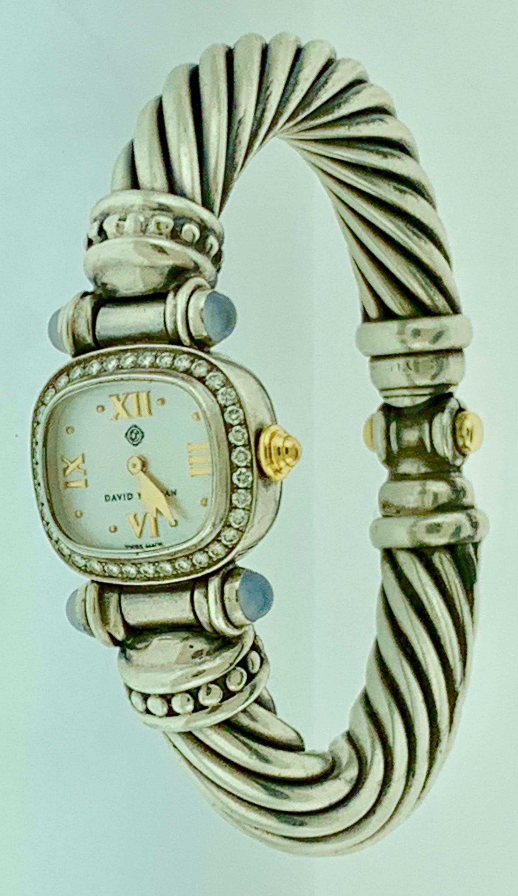 David Yurman Sterling silver and 14 K  gold cable bangle watch with diamond bezel. 
54 grams. Stamped on the back 