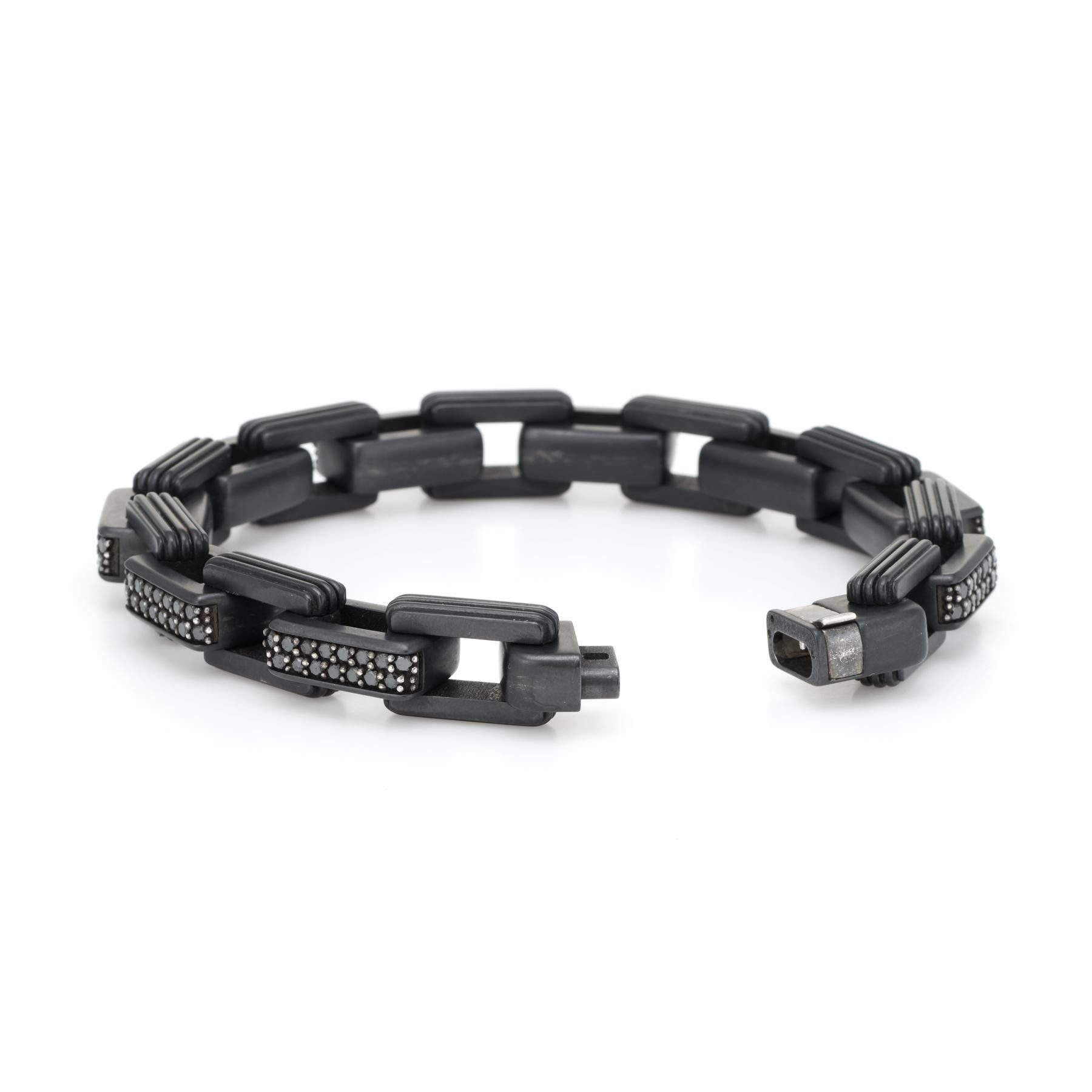 Pre Owned David Yurman chain link bracelet, crafted in sterling silver and titanium. 

Black diamonds are pave set into the links and total an estimated 6.75 carats. The diamonds are in excellent condition and free of cracks or chips.  

The