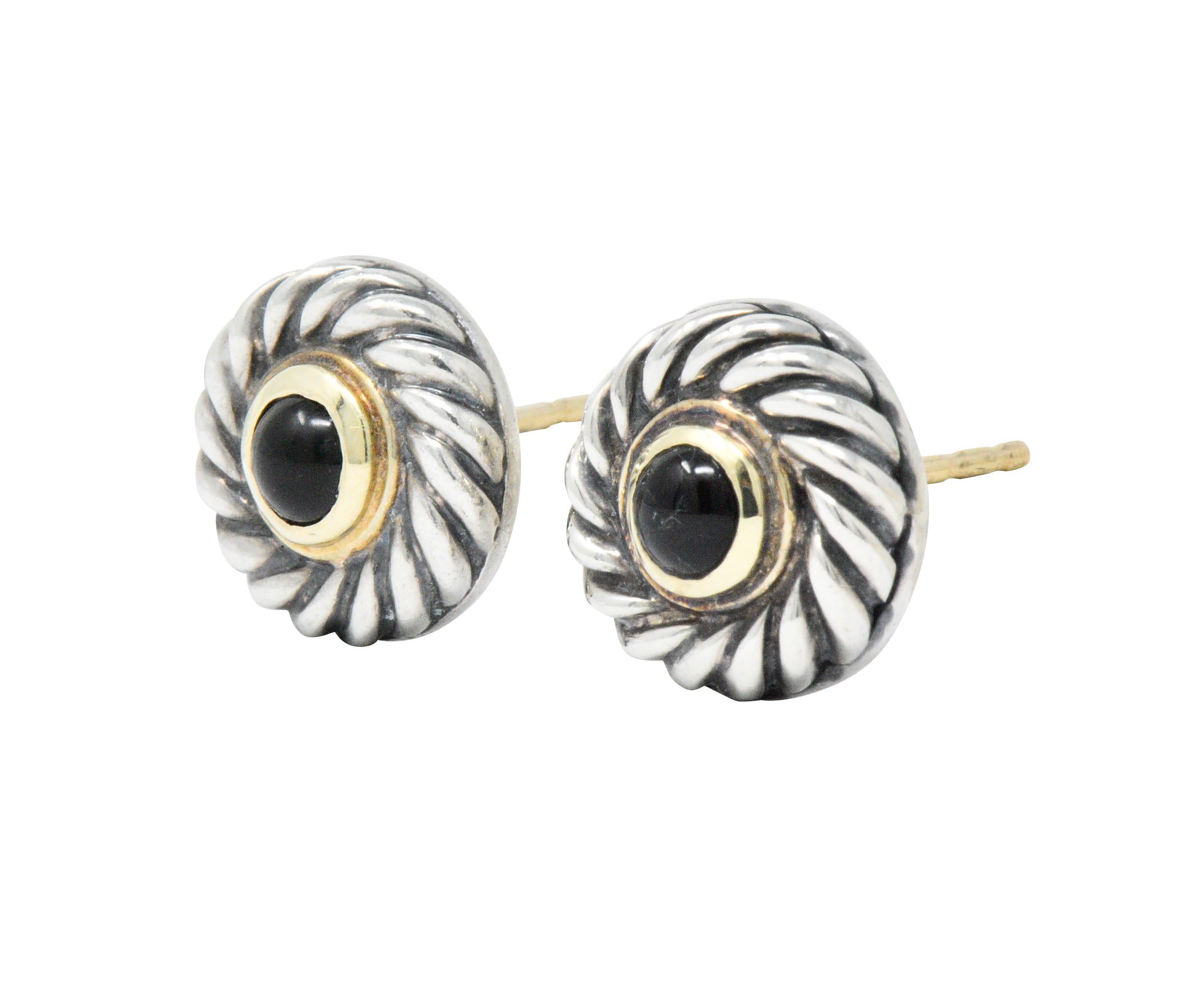 Featuring a sterling silver base with David Yurman signature cable twist design

Adorned with a round cabochon black onyx that is accented with 14k gold border

Pierced post earrings

Signed 925 DY 585

Known as Cookie Earrings

Measuring 11 mm in