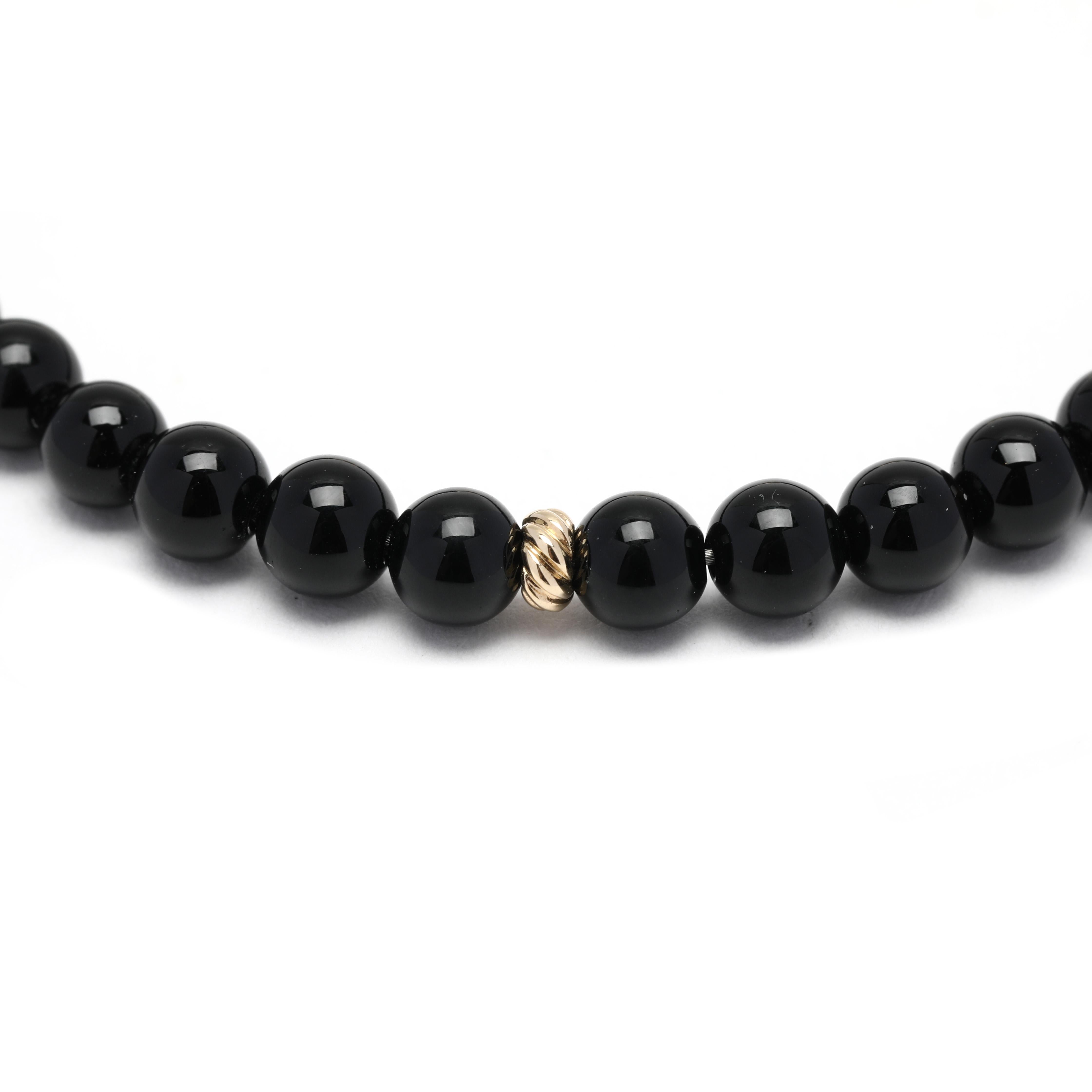 Enhance any outfit with this timeless David Yurman black onyx spiritual beads bracelet. This beautiful 18K yellow gold bracelet features 7 inches of intricate spiritual bead details inlaid with natural onyx beads. This classic gold bead bracelet