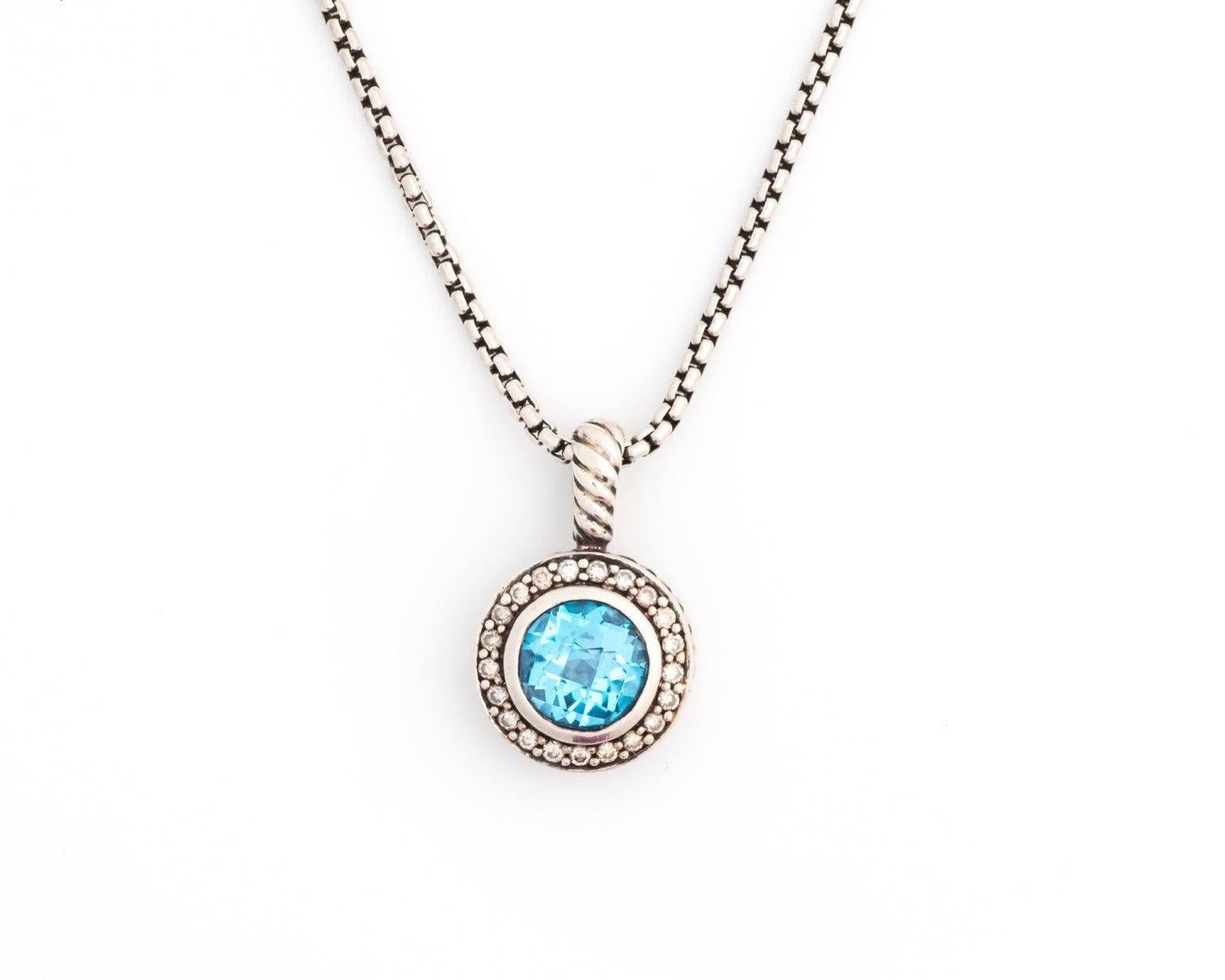 1980s David Yurman Petite Cerise Necklace with Blue Topaz and Diamonds

Features a round Blue Topaz bezel set center stone surrounded by a Diamond Halo. The Sterling Silver frame has open heart cutouts on the back. This allows light in to illuminate