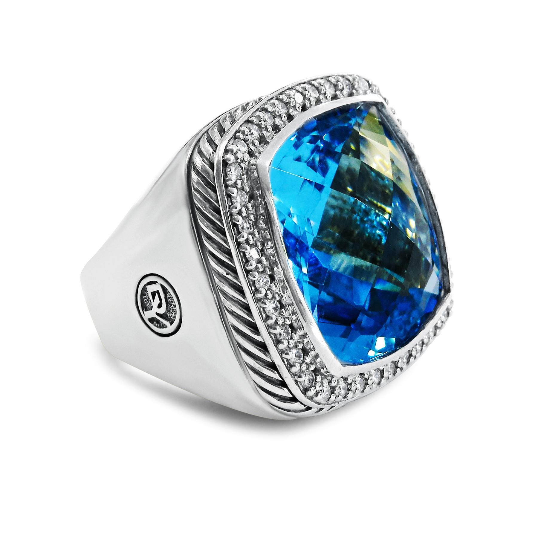 This classic and modern David Yurman ring features a princess-cut 20mm by 20mm  blue topaz and 0.44-carat diamonds that accents around it. It is further accented by a sterling silver shank design. It weighs 27.4 grams and the size is 7.25 to give