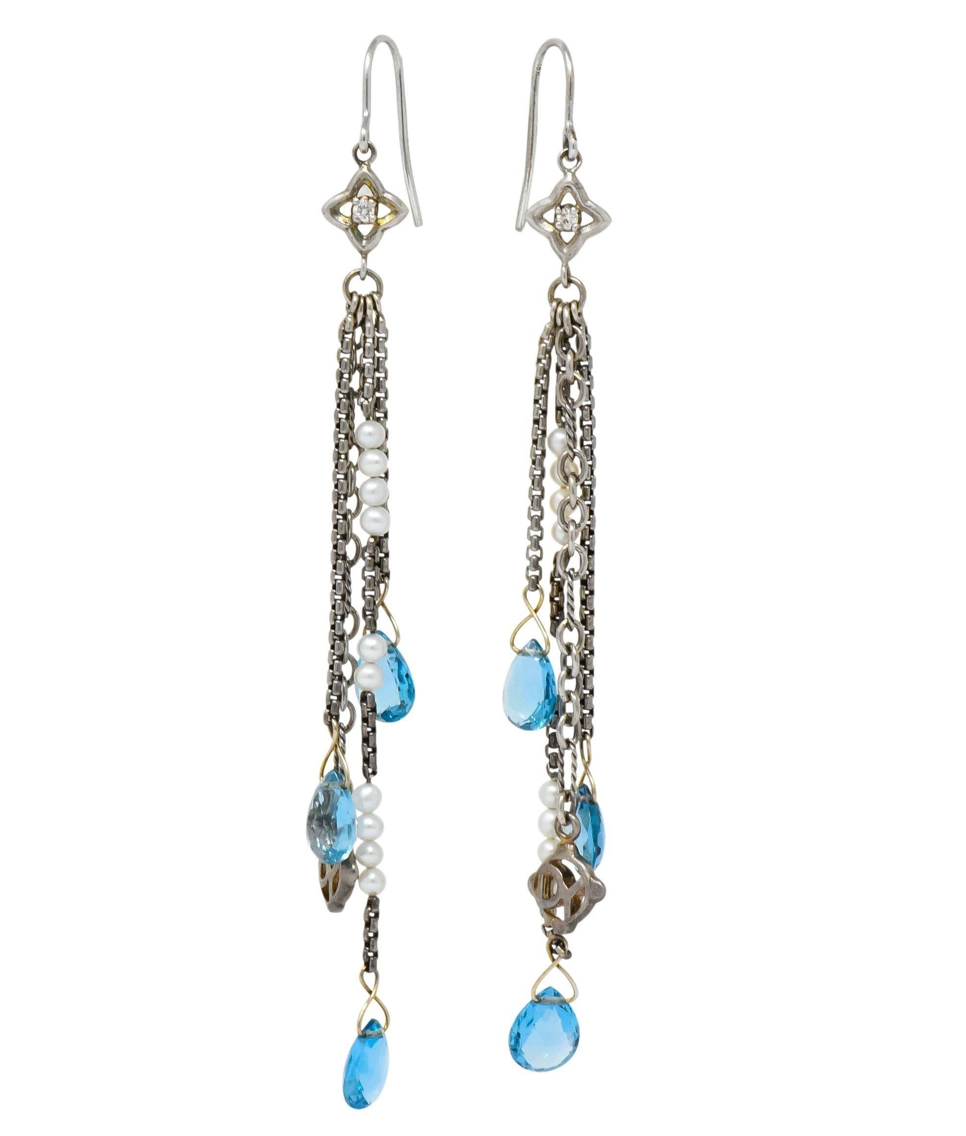 Tassel style drop earrings designed with a quatrefoil surmount centering a round brilliant cut diamond weighing in total 0.06 carat; eye-clean and white

Suspending silver cable chain strands, accented by 3.0 mm seed pearls and the David Yurman logo