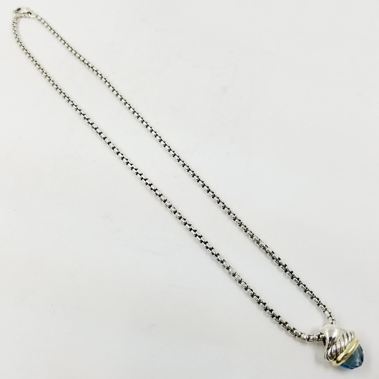 David Yurman Sterling Silver & 14 Karat Yellow Gold Necklace Featuring Blue Topaz Pendant. 16 Inches Long. Original MSRP $495. Professionally Cleaned and Polished to Remove Tarnish and Scratches. Comes with Yurman Travel Pouch.