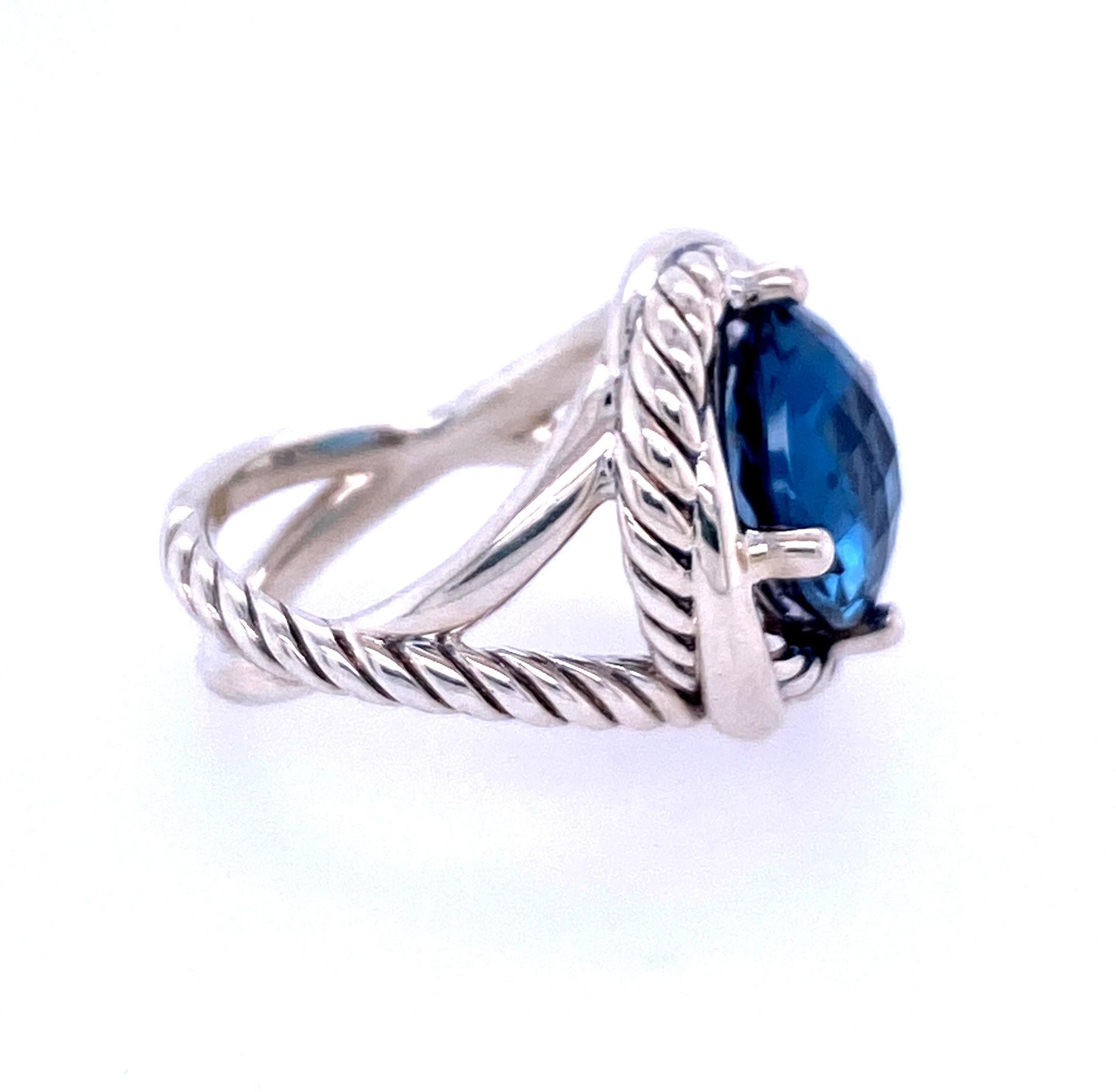 One sterling silver David Yurman ring (stamped DY 925) with one 11mm checkerboard cushion cut London Blue Topaz set in four prongs at 12, 3, 6 and 9 o'clock. The top of the ring meausres 17mm and the twisted double shank measures 11.25mm at the top,