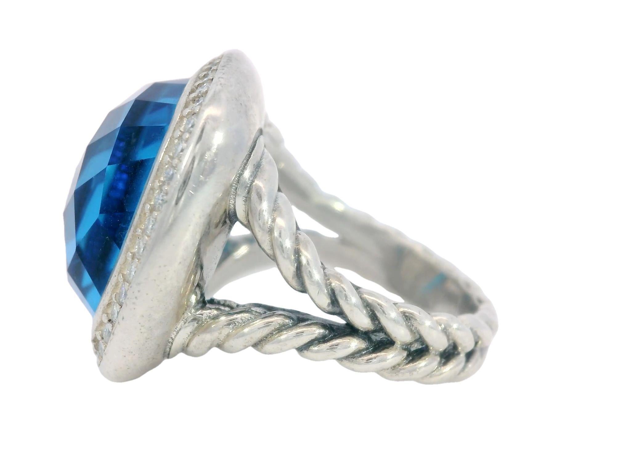 David Yurman Blue Topaz Sterling Silver Rope Ring with Diamonds

This David Yurman ring is truly a masterpiece. At its center is an impressive 24.82-carat blue topaz, cut in a cushion shape. The vivid blue color of the topaz is captivating,
