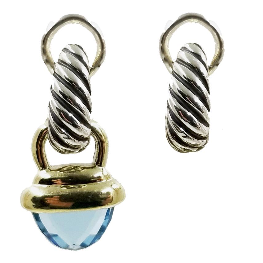 Sterling silver & 14 karat yellow gold earrings from David Yurman. The tapered cable huggie hoops are designed with a post and omega style clip. A pair of removable faceted blue topaz drops dangle below the ear. Total length is 1 inch with