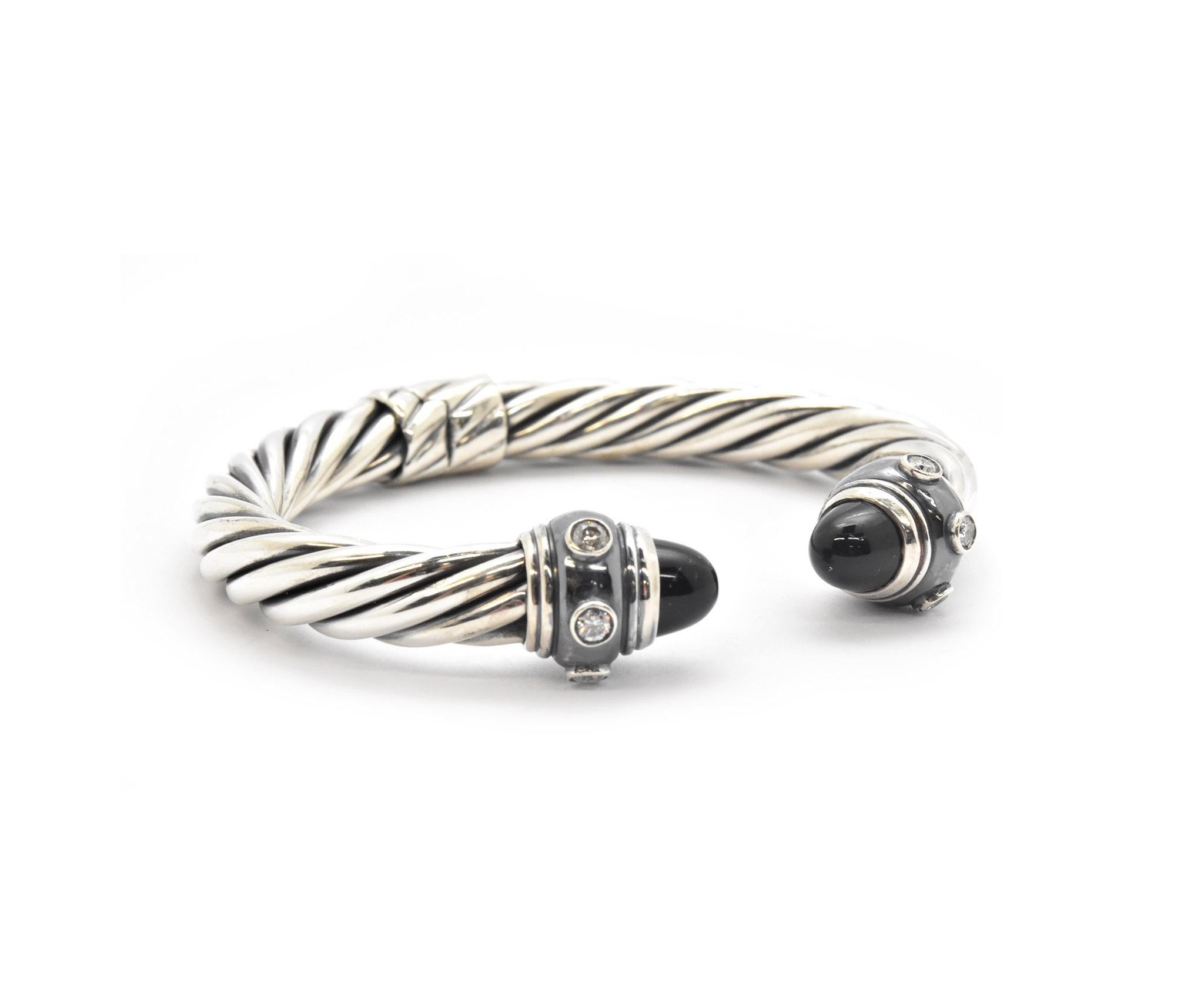 This bracelet is designed by David Yurman in The Waverly Cable Collection. The bangle bracelet is set with 0.50cttw diamonds on each end, and also with black onyx accents at each end of the bangle. This bracelet is designed in sterling silver and