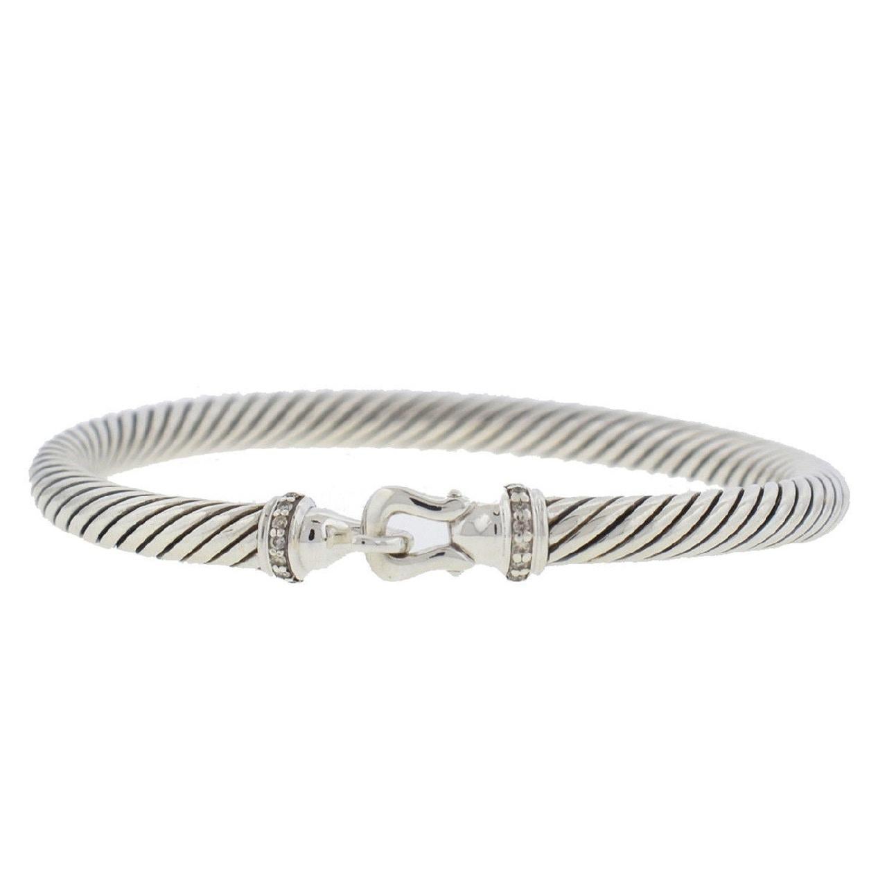 Touch of style, value, and greatness, this David Yurman Cable Buckle Bracelet is made with Sterling silver and it features pave diamonds 0.06 total carat weight cable with a hook clasp. It weighs 30.2 grams and it is 5mm wide to give you a