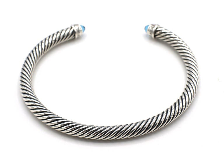 David Yurman Cable Classic Collection® Sterling Silver Bracelet with Blue Topaz and Diamonds
Metal: Sterling silver
Weight: 25.42 grams
Gemstone: Blue topaz
Width: 5mm
Diamonds: Approx. .07 CTW G VS
Inside diameter: 60mm
Signed: D.Y. 925
Retail: