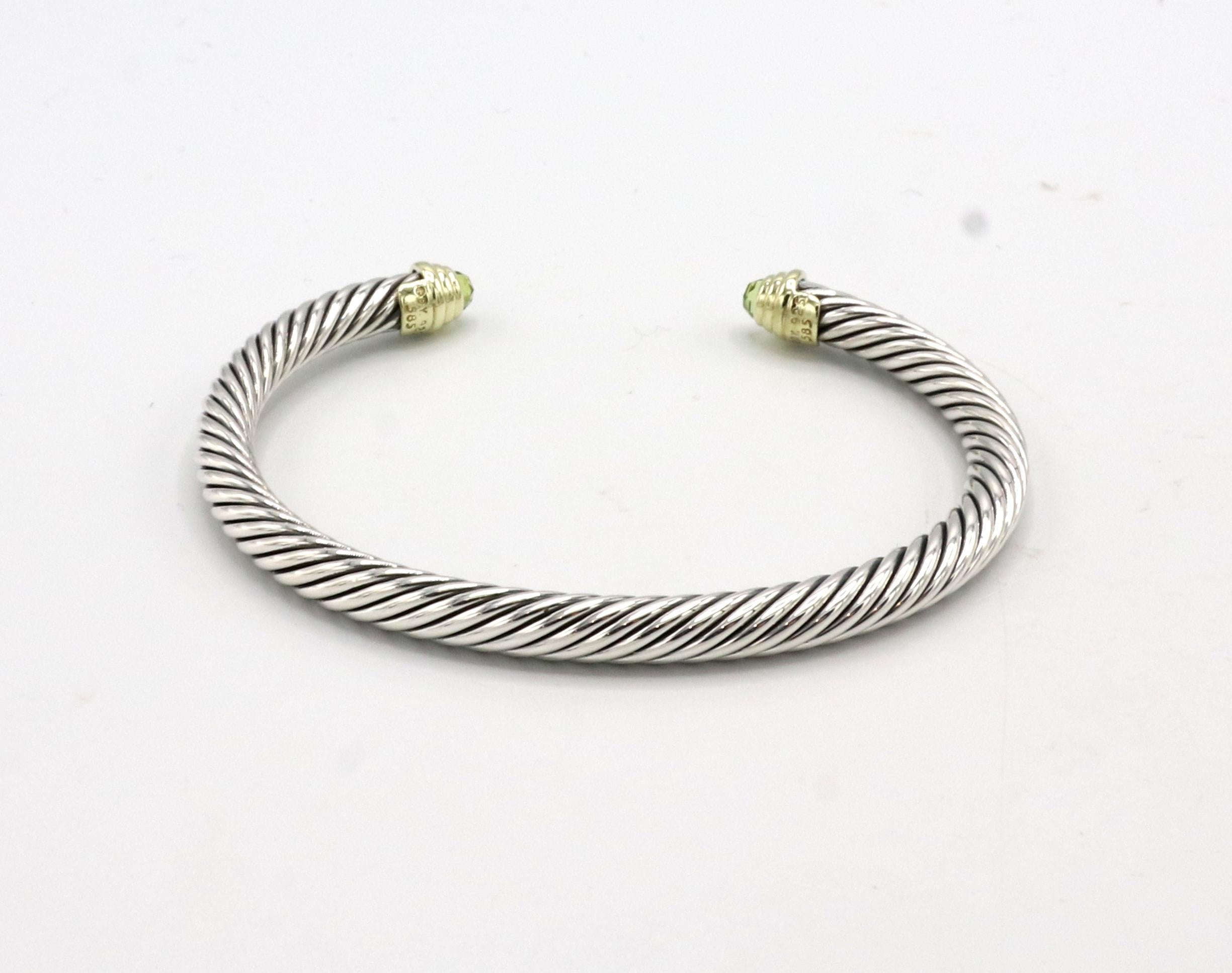 David Yurman Cable Classic Sterling Silver & Gold Peridot Bangle Bracelet 
Metal: Sterling silver & 14k yellow gold
Weight: 26.19 grams
Width: 5mm
Circumference: Approx. 6.75 inches
Inside diameter: 60mm
Outside diameter: 68.5mm
Retail: $650