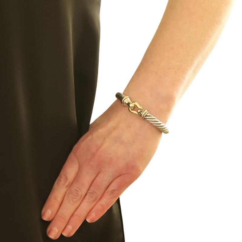 Brand: David Yurman
Collection: Cable Classics
Design:  Buckle bracelet

Metal Content: Sterling Silver 
14k Yellow Gold

Bracelet Style: Bangle
Fastening Type: Fold-Over Clasp
Features: Cable Detailing

Measurements

Side Width: 11/32