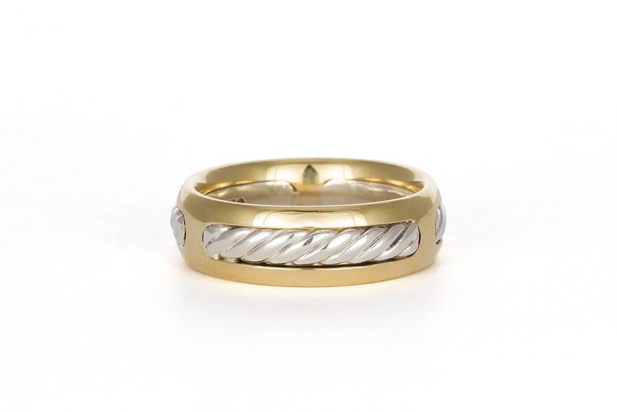 We are pleased to offer this David Yurman Cable Ring. A very stylish design from David Yurman, the four piece Cable Band will make a great gift for him that he is sure to love! This ring is crafted in sterling silver and 18k Yellow gold. It features