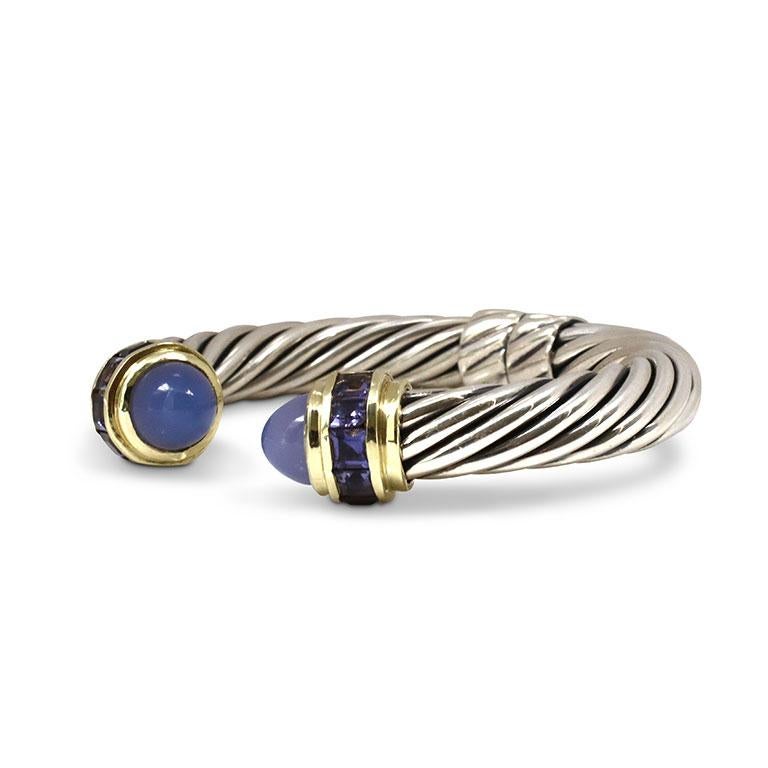 Authentic David Yurman Cable silver bangle bracelet, crafted in sterling silver and 14 karat yellow gold. Featuring two chalcedony cabochons and five faceted amethysts. Bracelet measures 9.5mm in width and can fit up to a size 5 ½ wrist. Signed