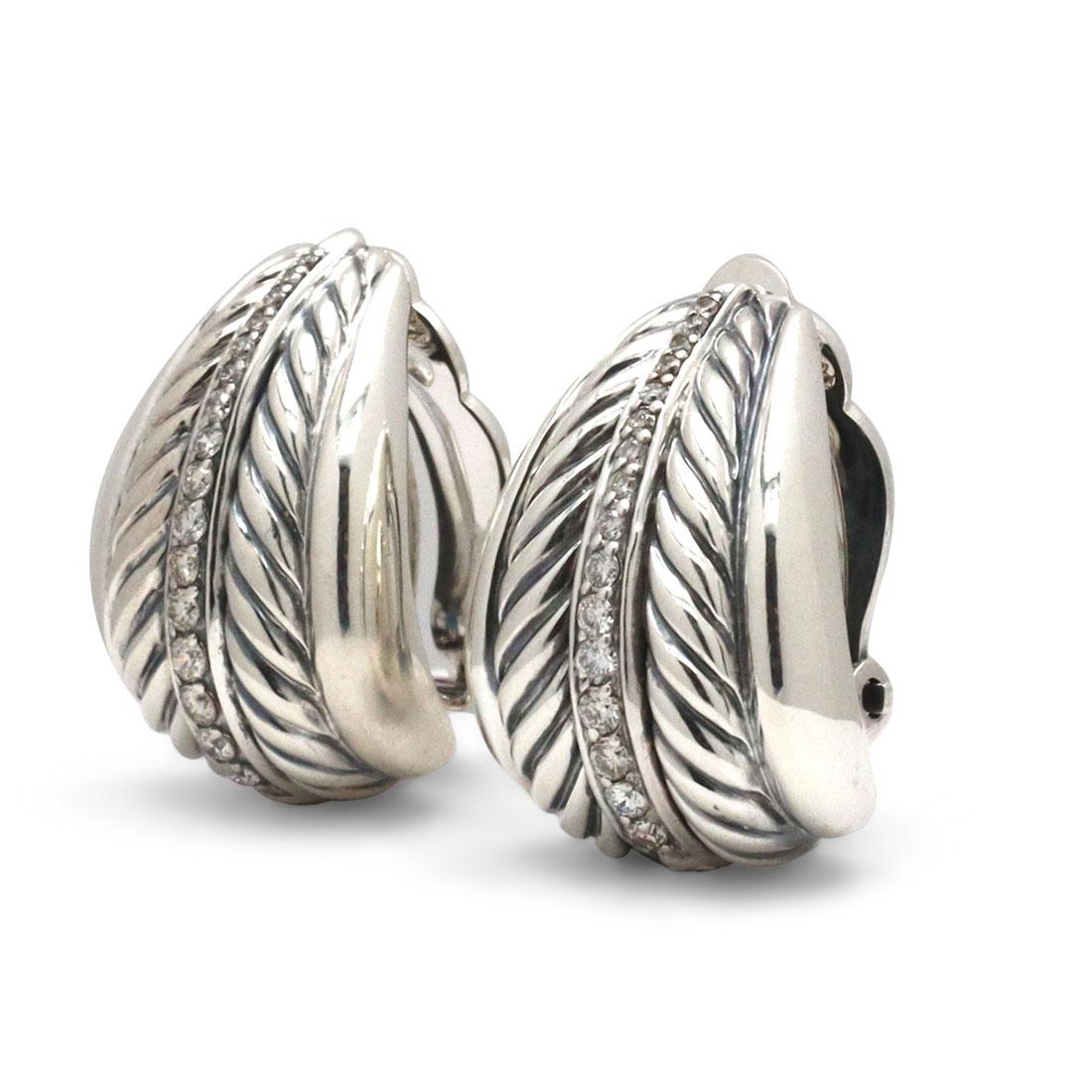 Authentic David Yurman cable earrings crafted in Sterling Silver a row of round brilliant diamonds is situated in the center of Yurman's signature cable design. The pair has an estimated total carat weight of .36ct. The earrings measure .95 inches