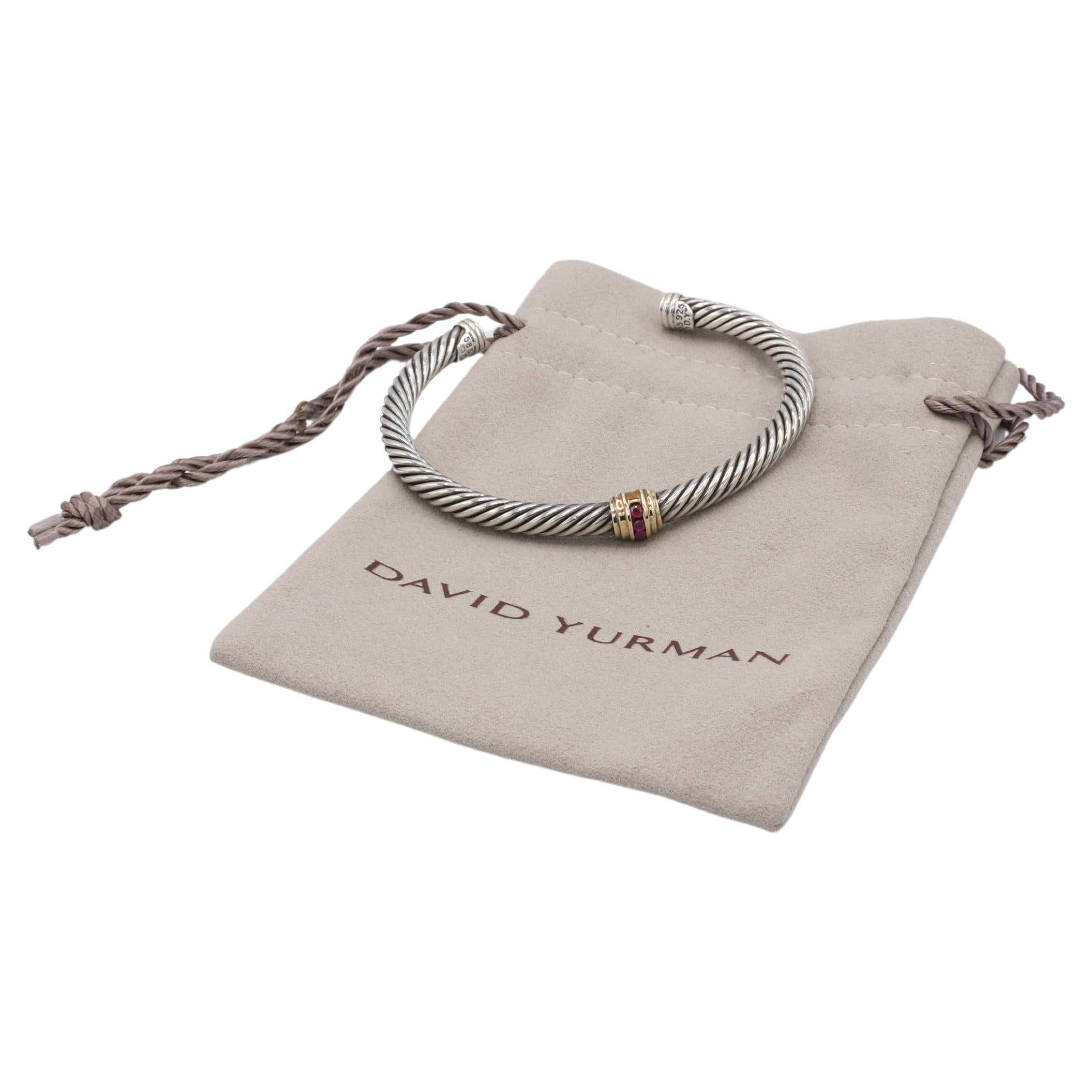 David Yurman Cable Sterling Silver & Gold Ruby Station Cuff Bracelet 
Metal: Sterling silver & 14k yellow gold
Weight: 26.6 grams
Circumference: 6.75 inches
Inside Diameter: 2.5 inches
Width: 5mm

